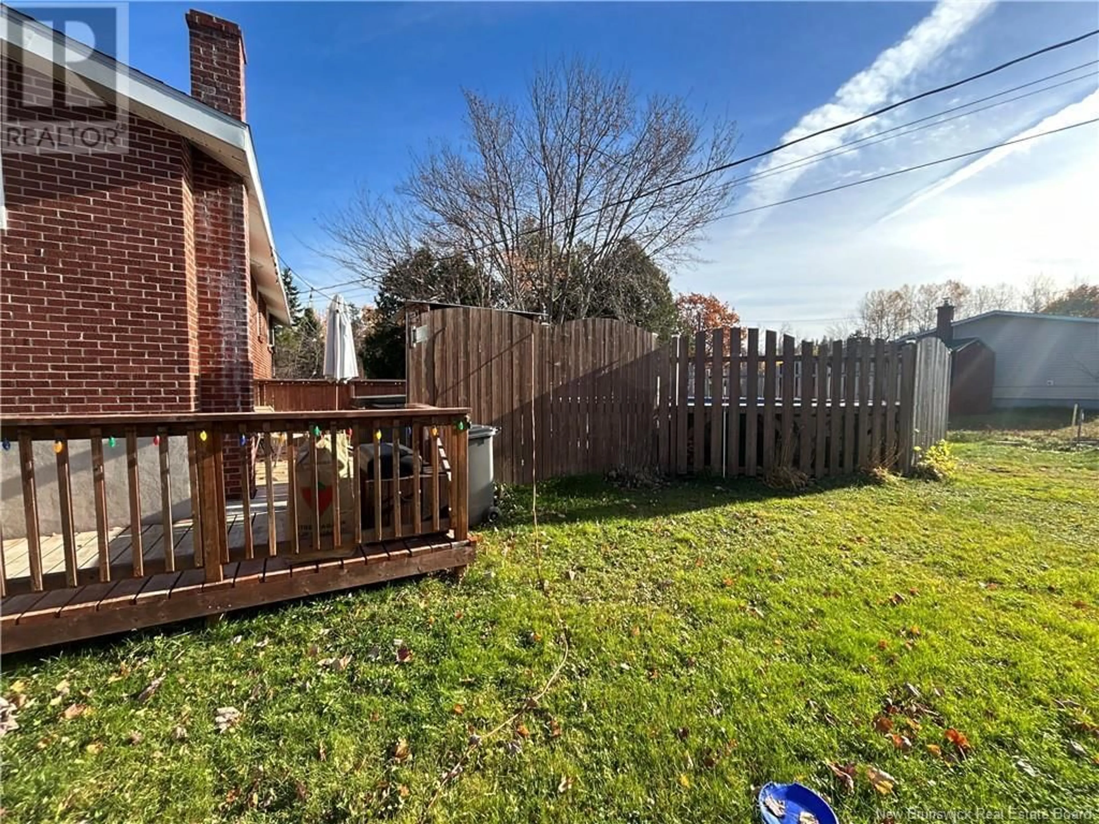 Frontside or backside of a home, the fenced backyard for 626 Wellington, Miramichi New Brunswick E1N3M4