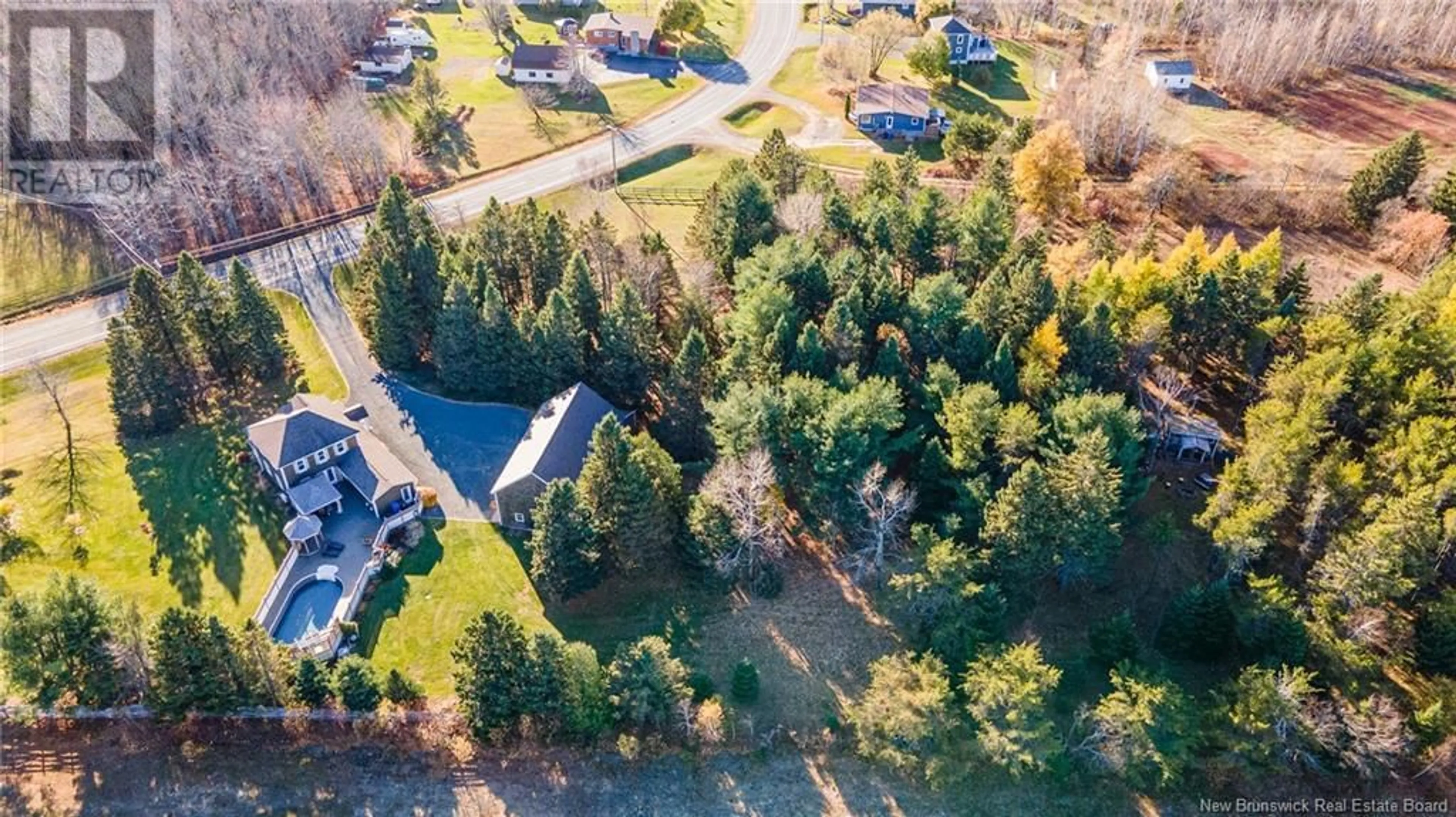 A pic from exterior of the house or condo, the fenced backyard for 1575 Chemin Rivière-à-la-Truite Road, Rivière-À-La-Truite New Brunswick E1X3N8