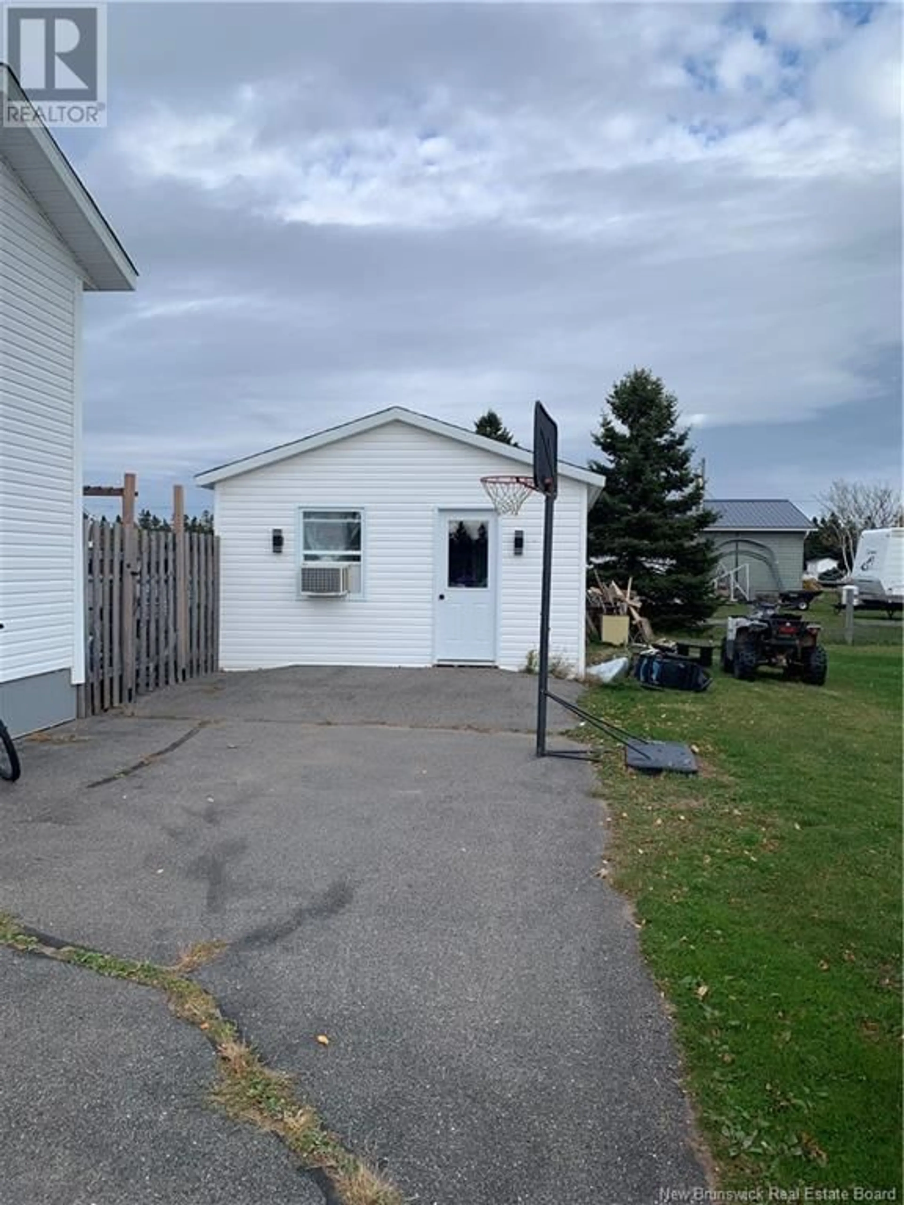 Frontside or backside of a home, the fenced backyard for 34 ARLEQUIN, Saint-Marie-Saint-Raphaël New Brunswick E8T1N4