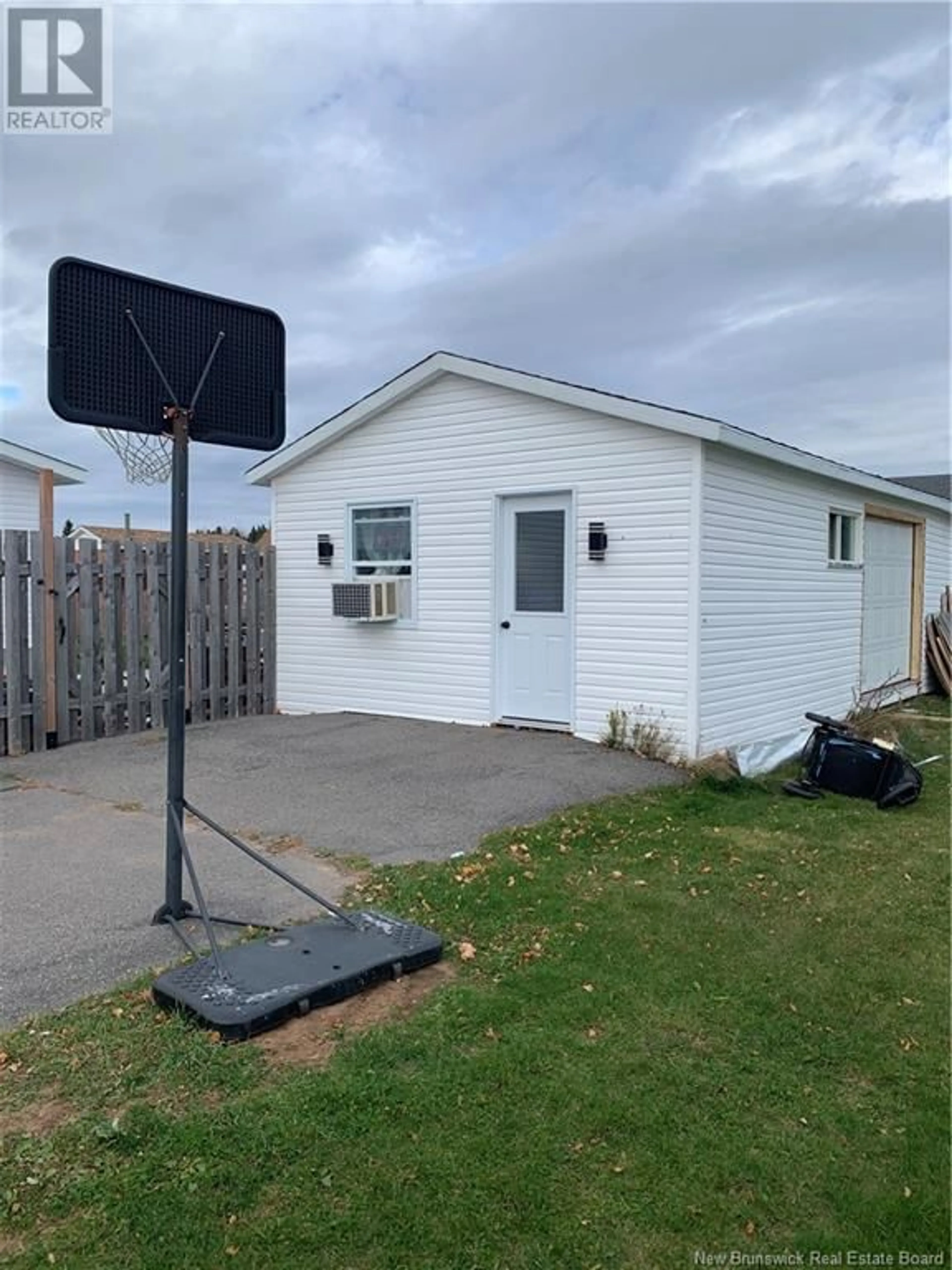 Frontside or backside of a home, the fenced backyard for 34 ARLEQUIN, Saint-Marie-Saint-Raphaël New Brunswick E8T1N4