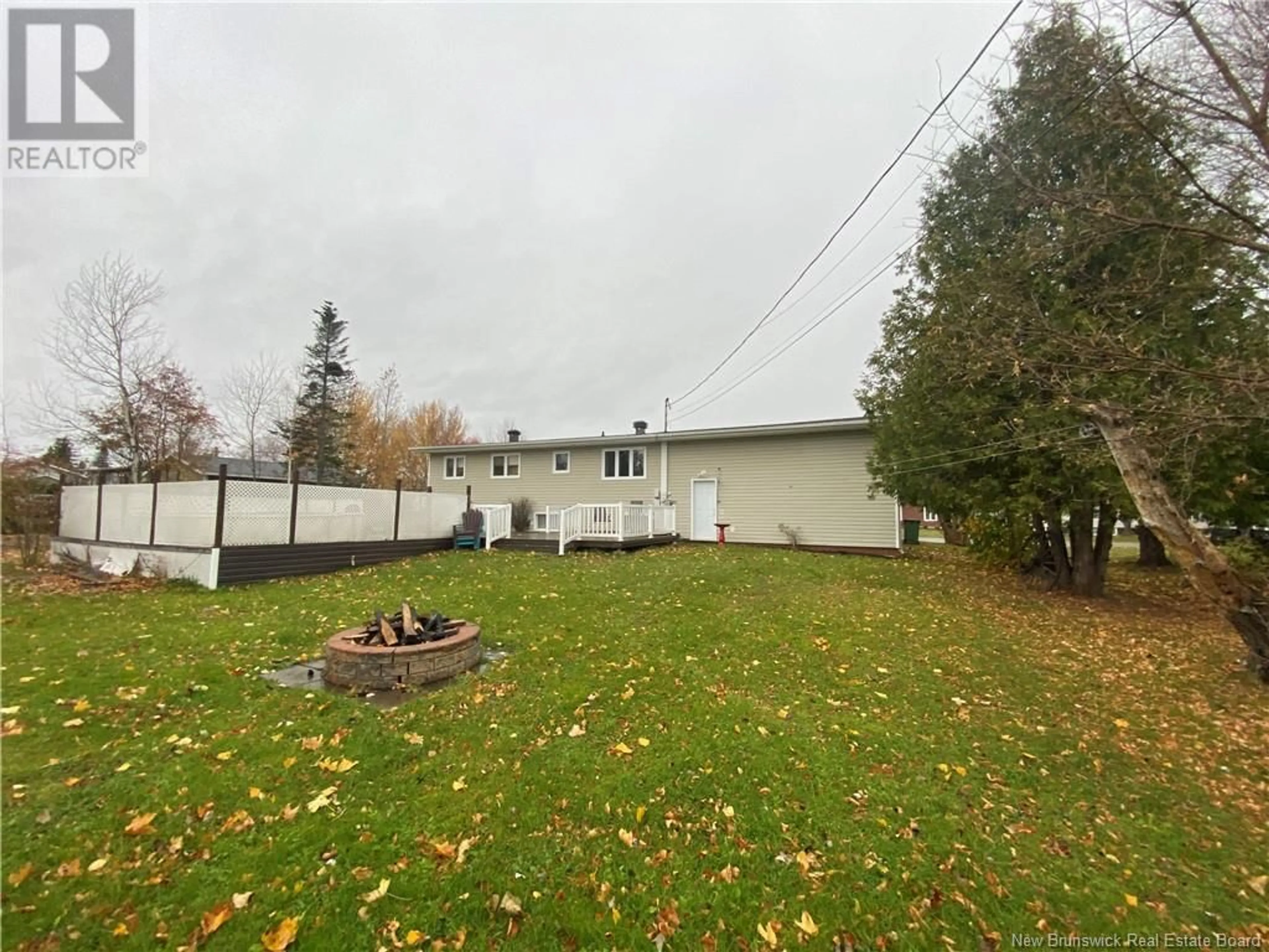 Frontside or backside of a home, the fenced backyard for 211 Foulem, Beresford New Brunswick E8K1N1