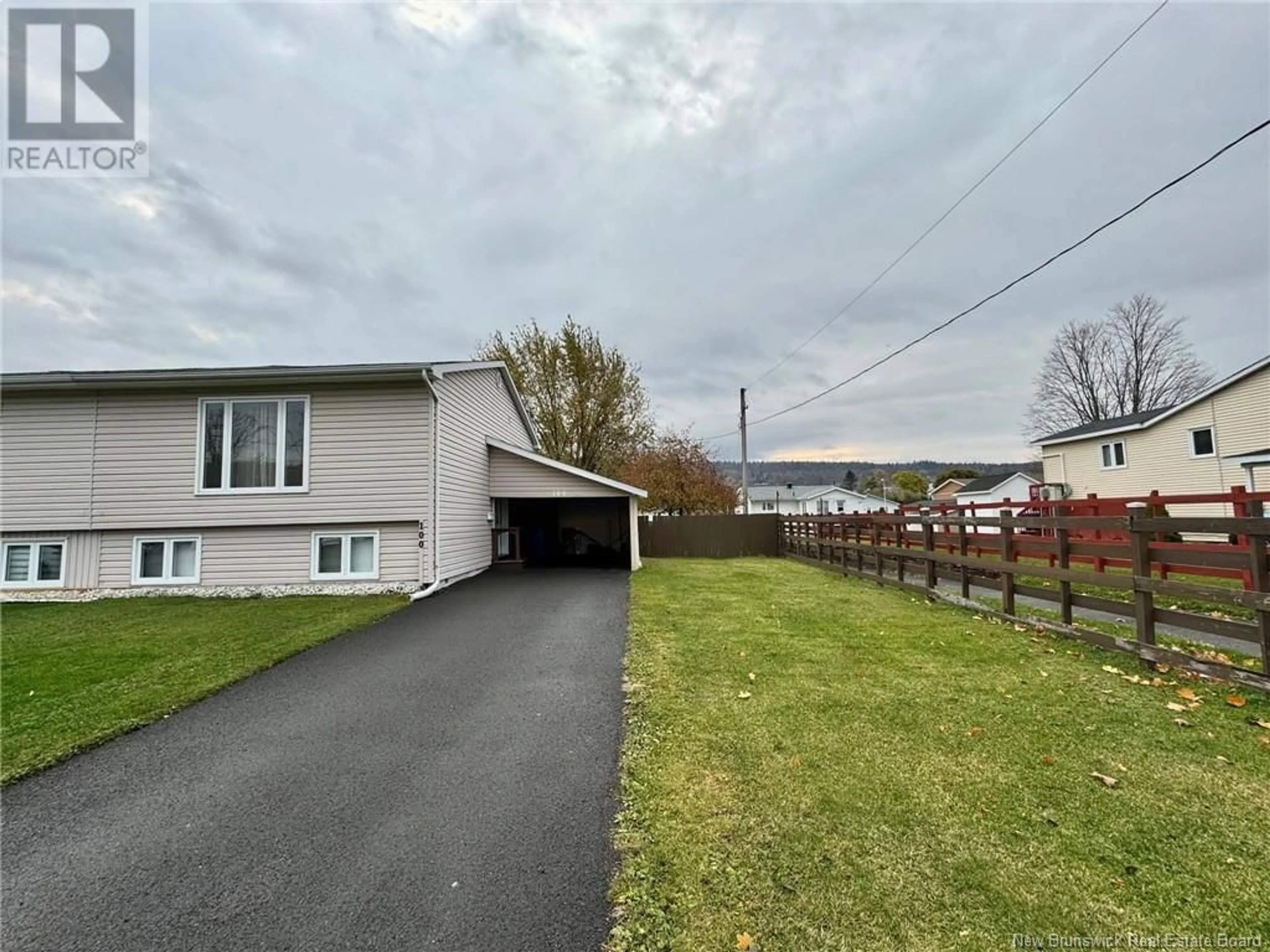 Frontside or backside of a home, the fenced backyard for 100 Dover Street, Campbellton New Brunswick E3N1P8