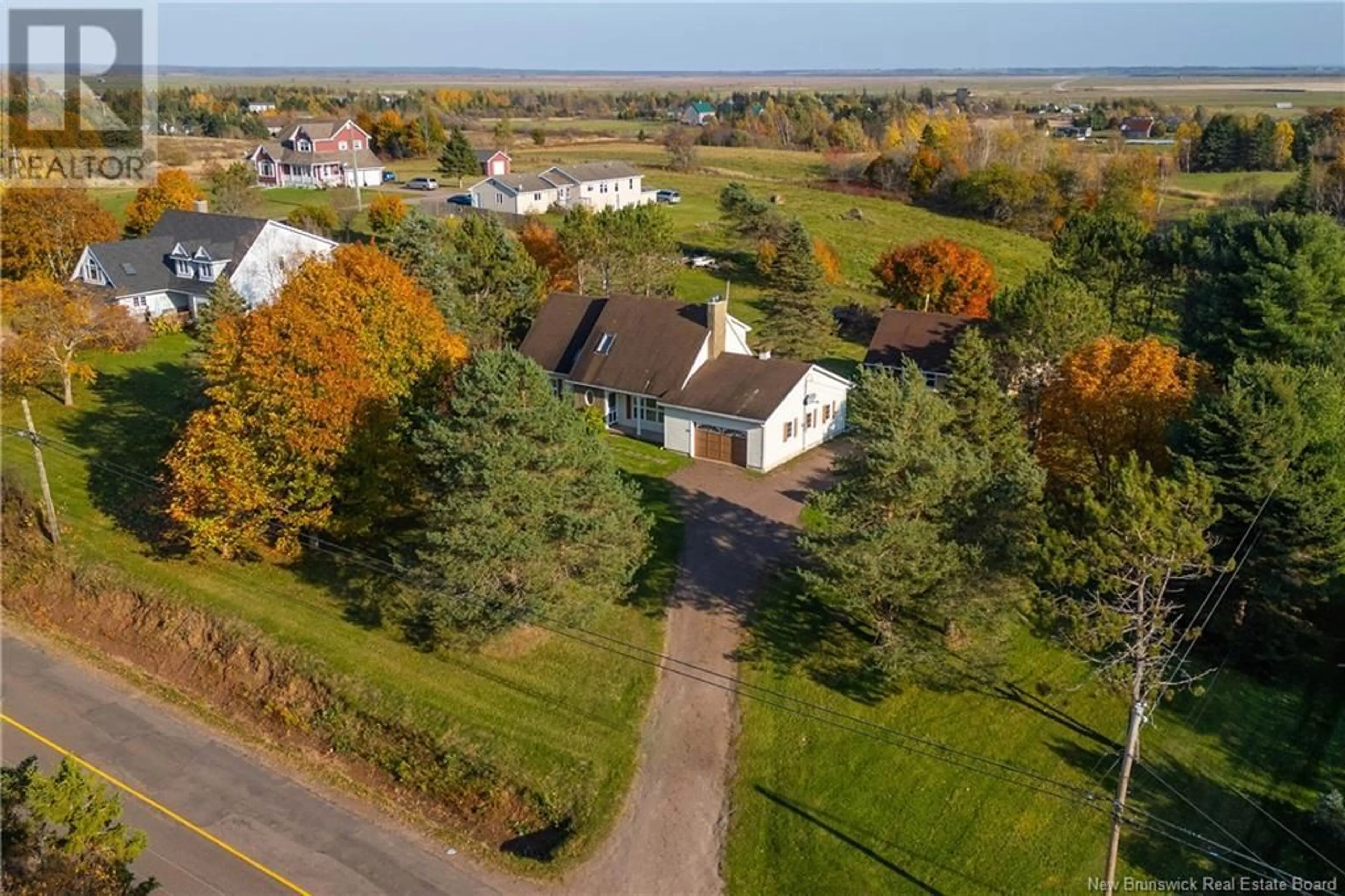 A pic from exterior of the house or condo, the fenced backyard for 77 Pond Shore Road, Sackville New Brunswick E4L1L4