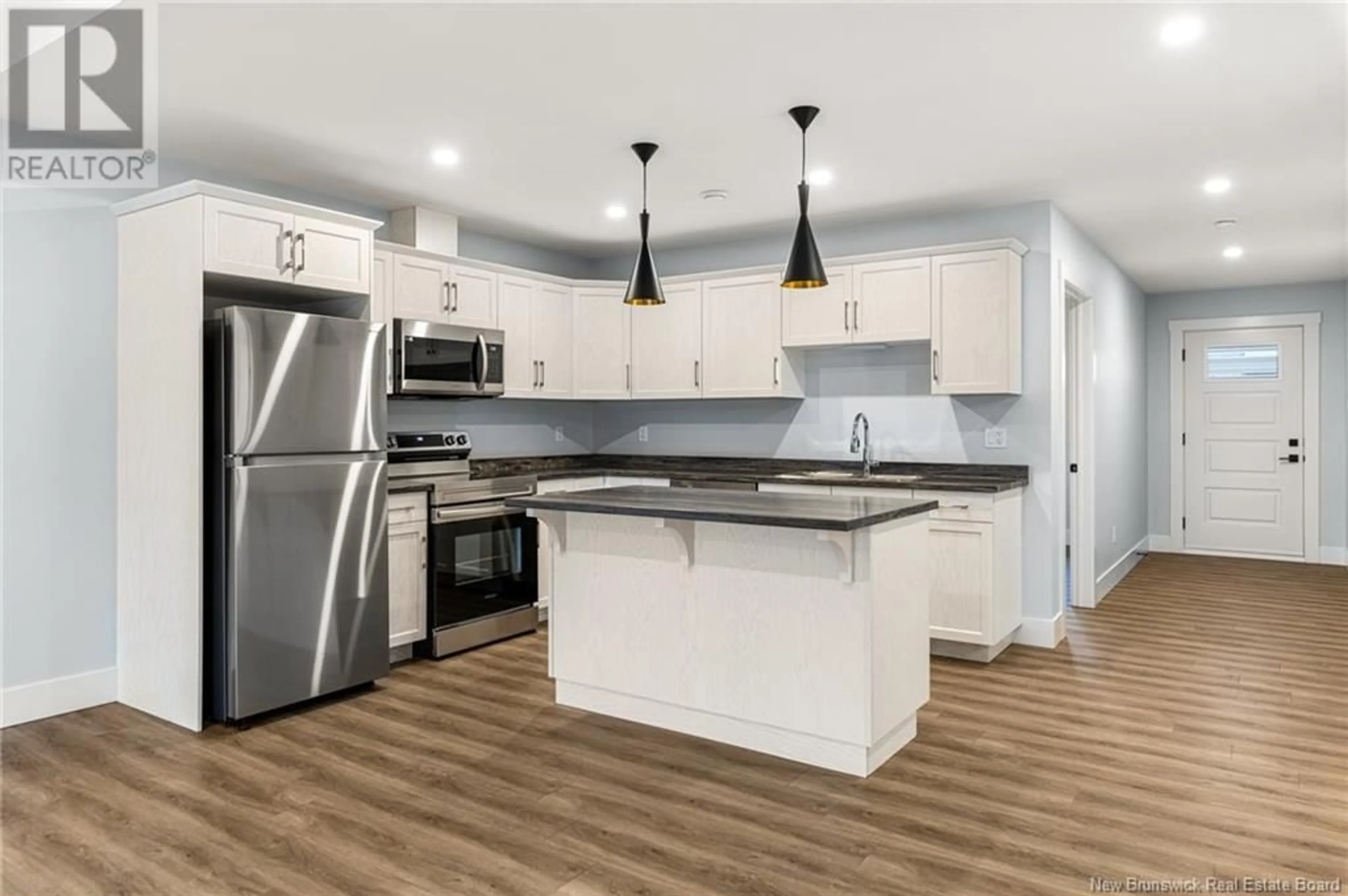 Open concept kitchen for 20-27 Domaine des Cèdres, Cocagne New Brunswick E4R0H7