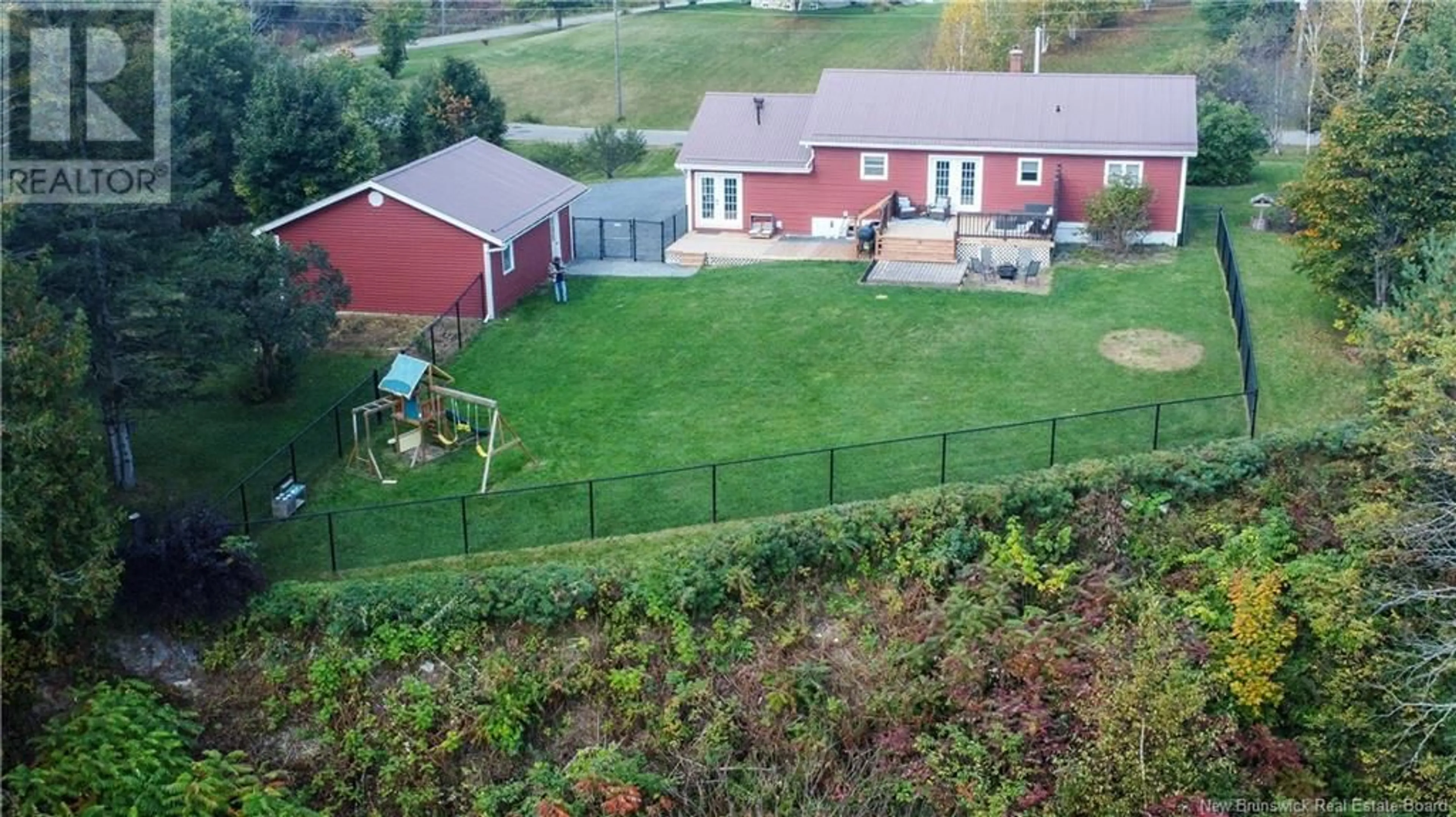 A pic from exterior of the house or condo, the fenced backyard for 31 Chantler Drive, Perth-Andover New Brunswick E7H1R9