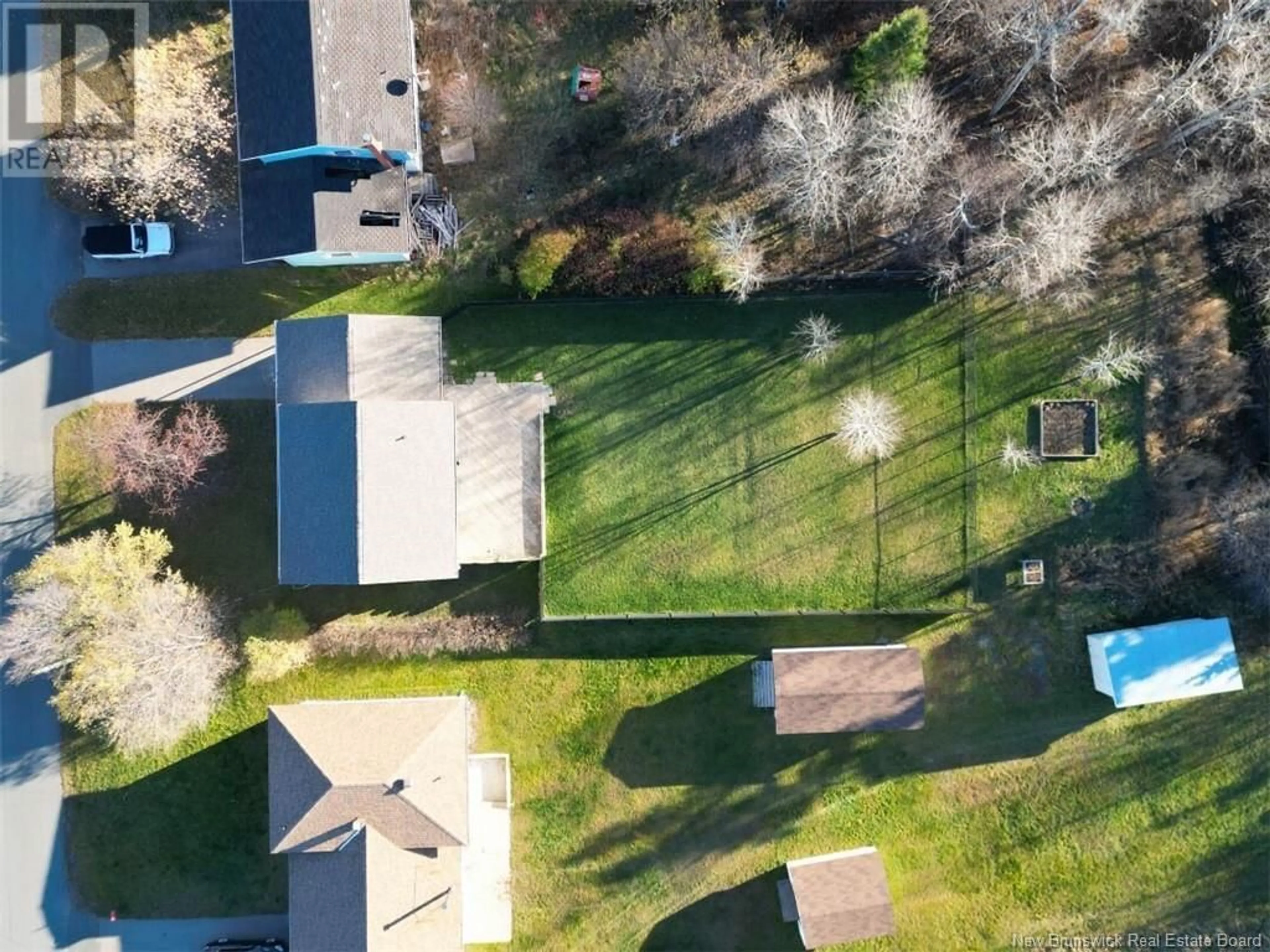 Frontside or backside of a home, the fenced backyard for 84 Chaleur, Belledune New Brunswick E8G1Z4