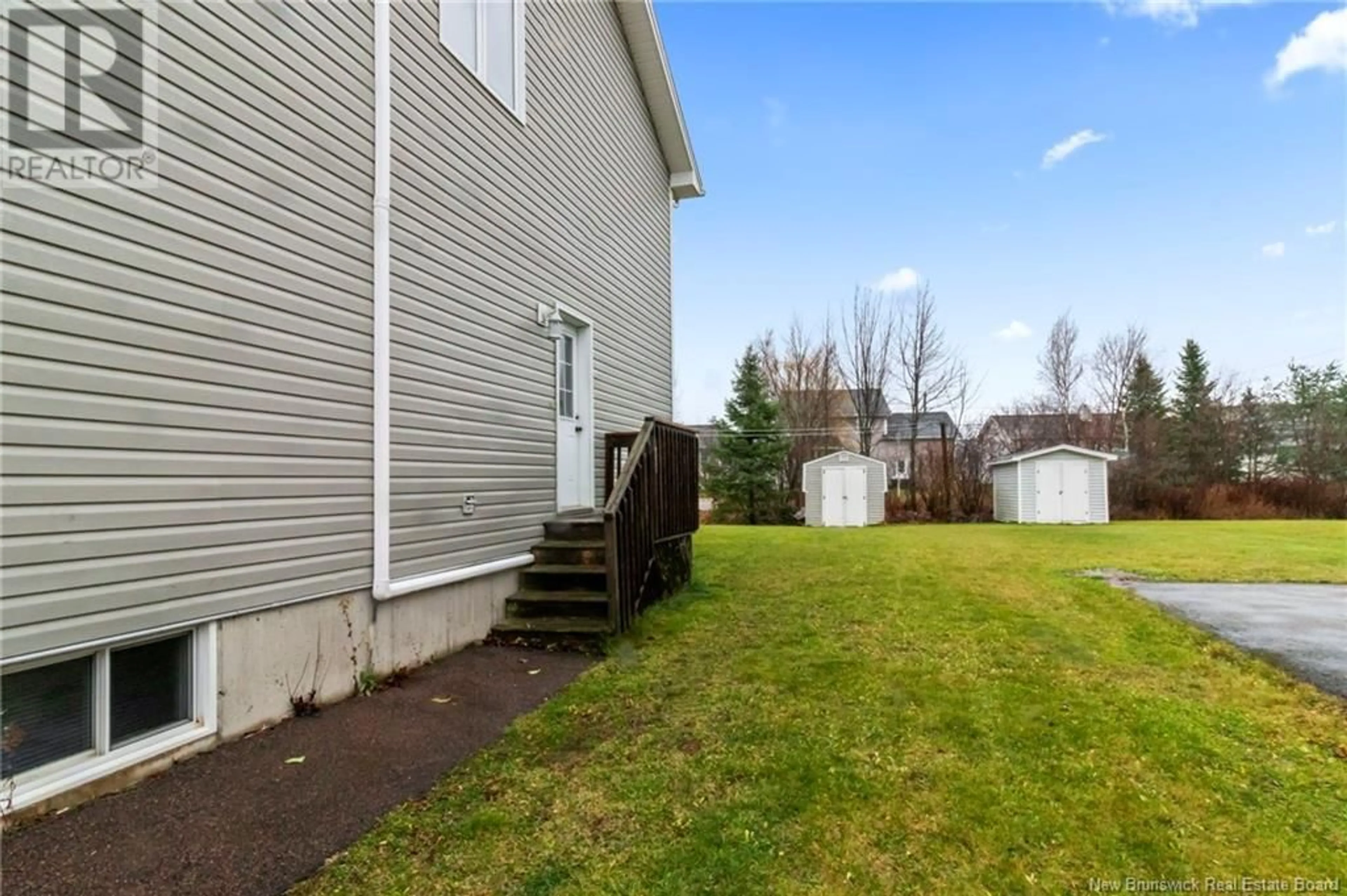 Frontside or backside of a home, the fenced backyard for 34 Limestone Drive, Moncton New Brunswick E1G5P4