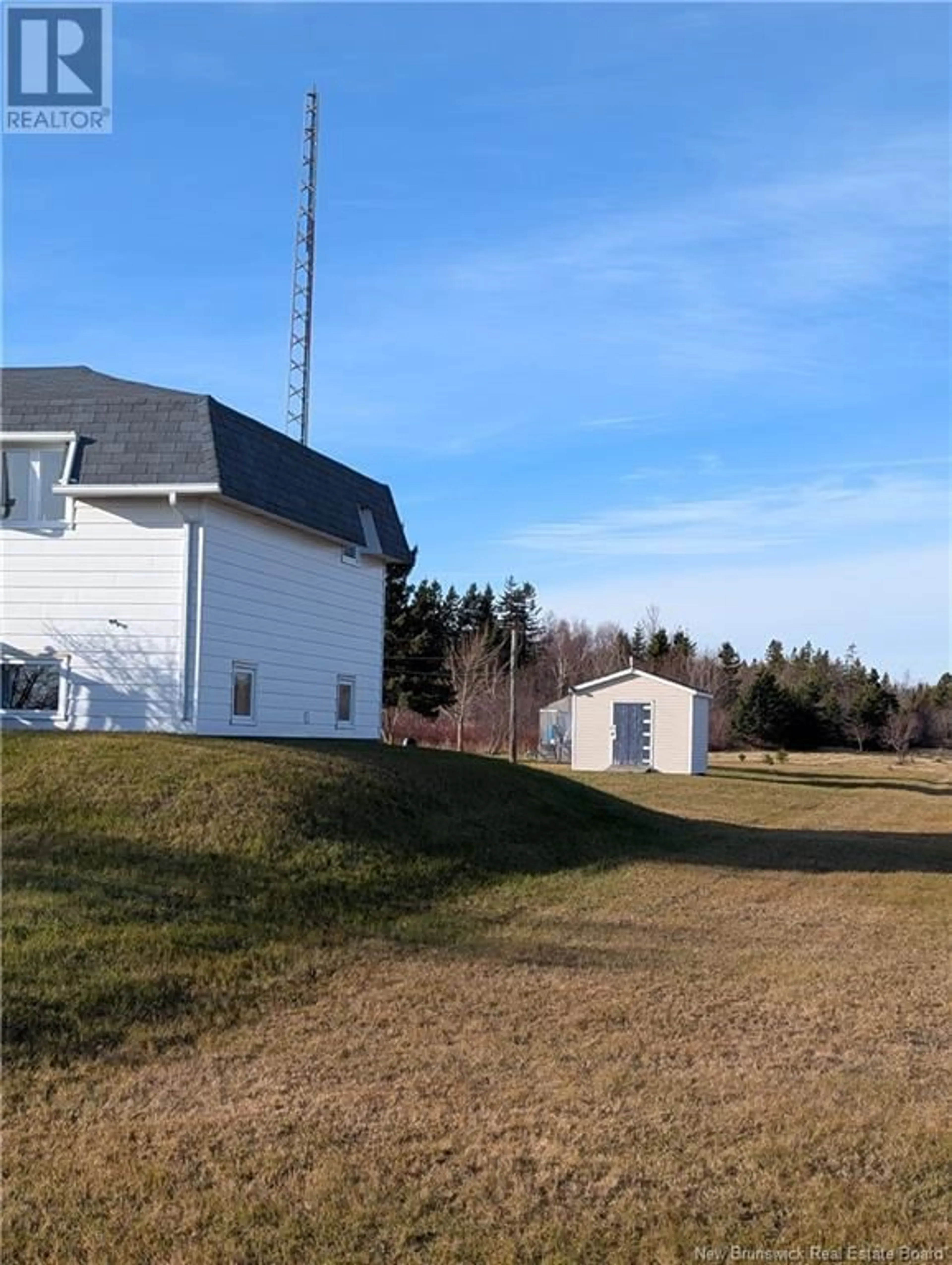 Frontside or backside of a home, the fenced backyard for 414 Saint-Raphael Nord, Saint-Marie-Saint-Raphaël New Brunswick E8T1R9