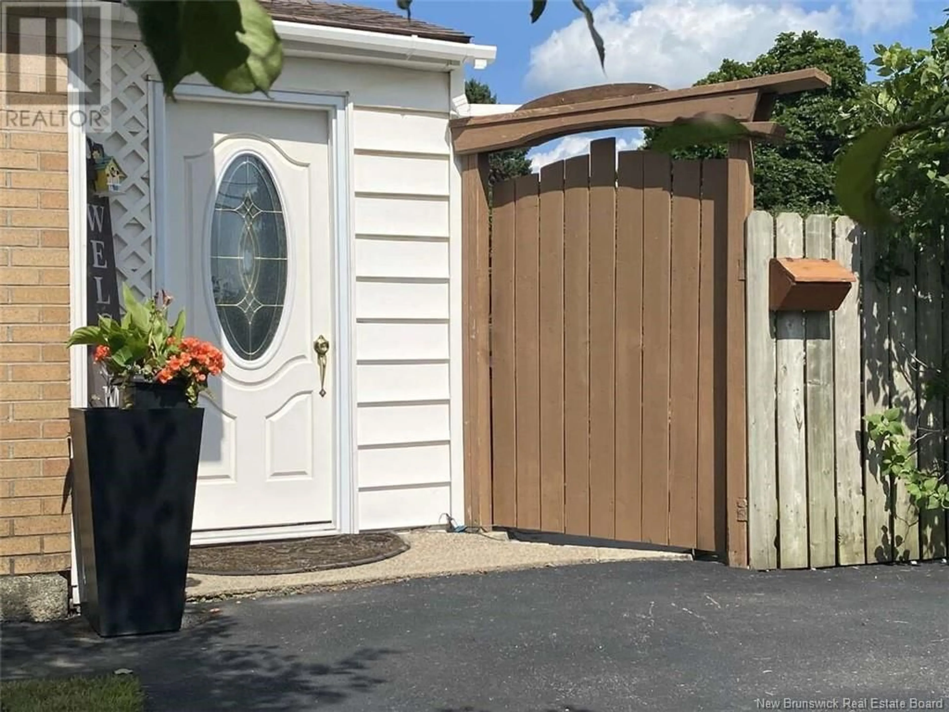 Frontside or backside of a home, the fenced backyard for 97 University, Miramichi New Brunswick E1N2V6