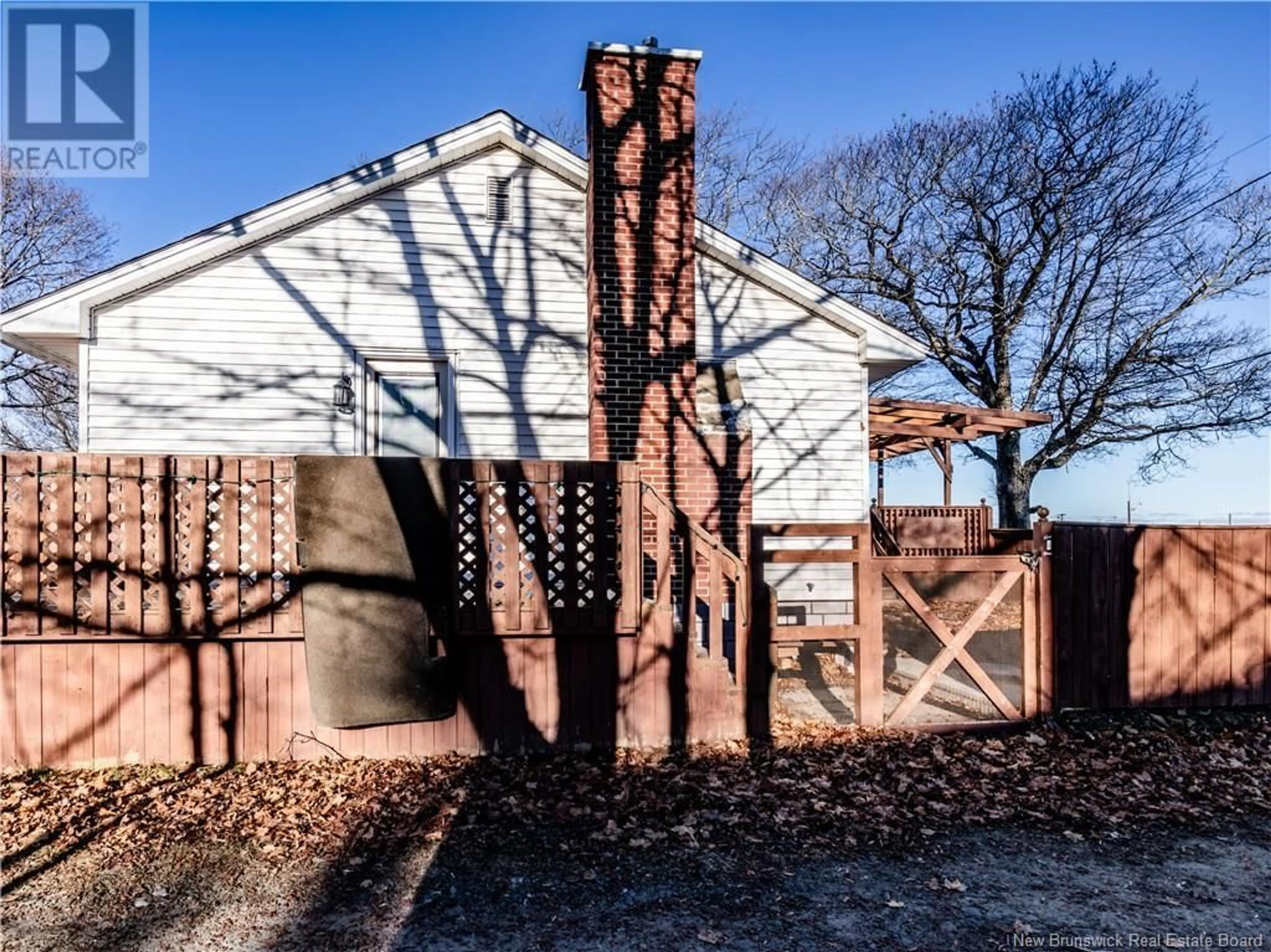 Frontside or backside of a home, the fenced backyard for 9344 Main Street, Richibucto New Brunswick E4W4C8