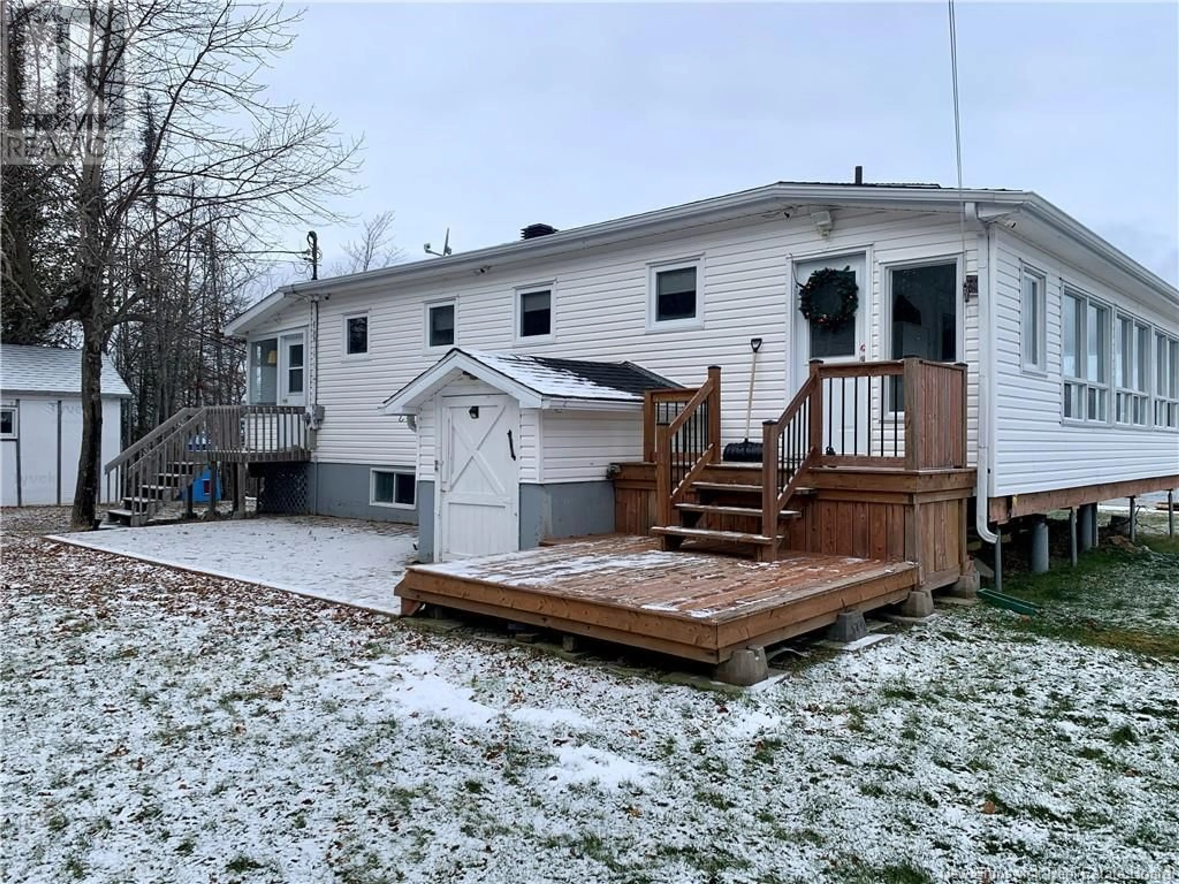 Frontside or backside of a home, the fenced backyard for 279 Goulette Point Road, Charlo New Brunswick E8E2K5