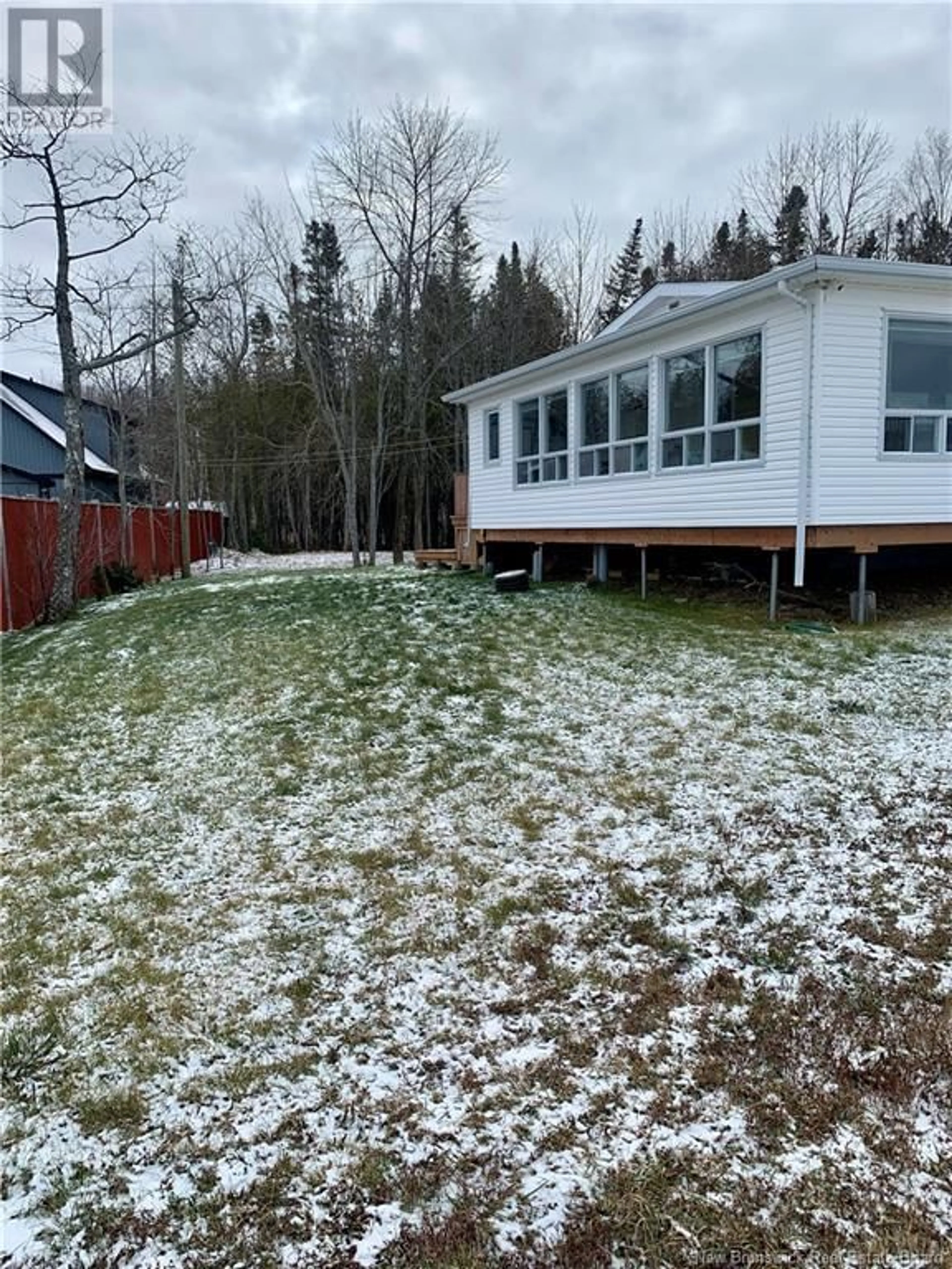 Frontside or backside of a home, the fenced backyard for 279 Goulette Point Road, Charlo New Brunswick E8E2K5