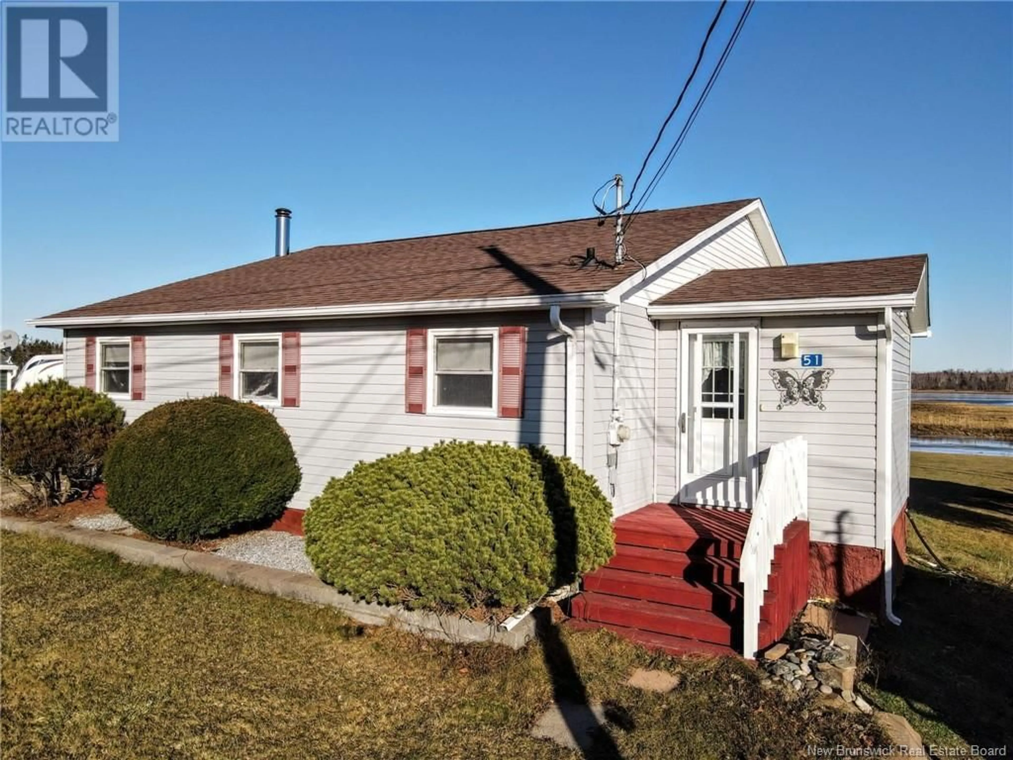 Home with vinyl exterior material, street for 51 Thibodeau Street, Grand-Barachois New Brunswick E4P8P4