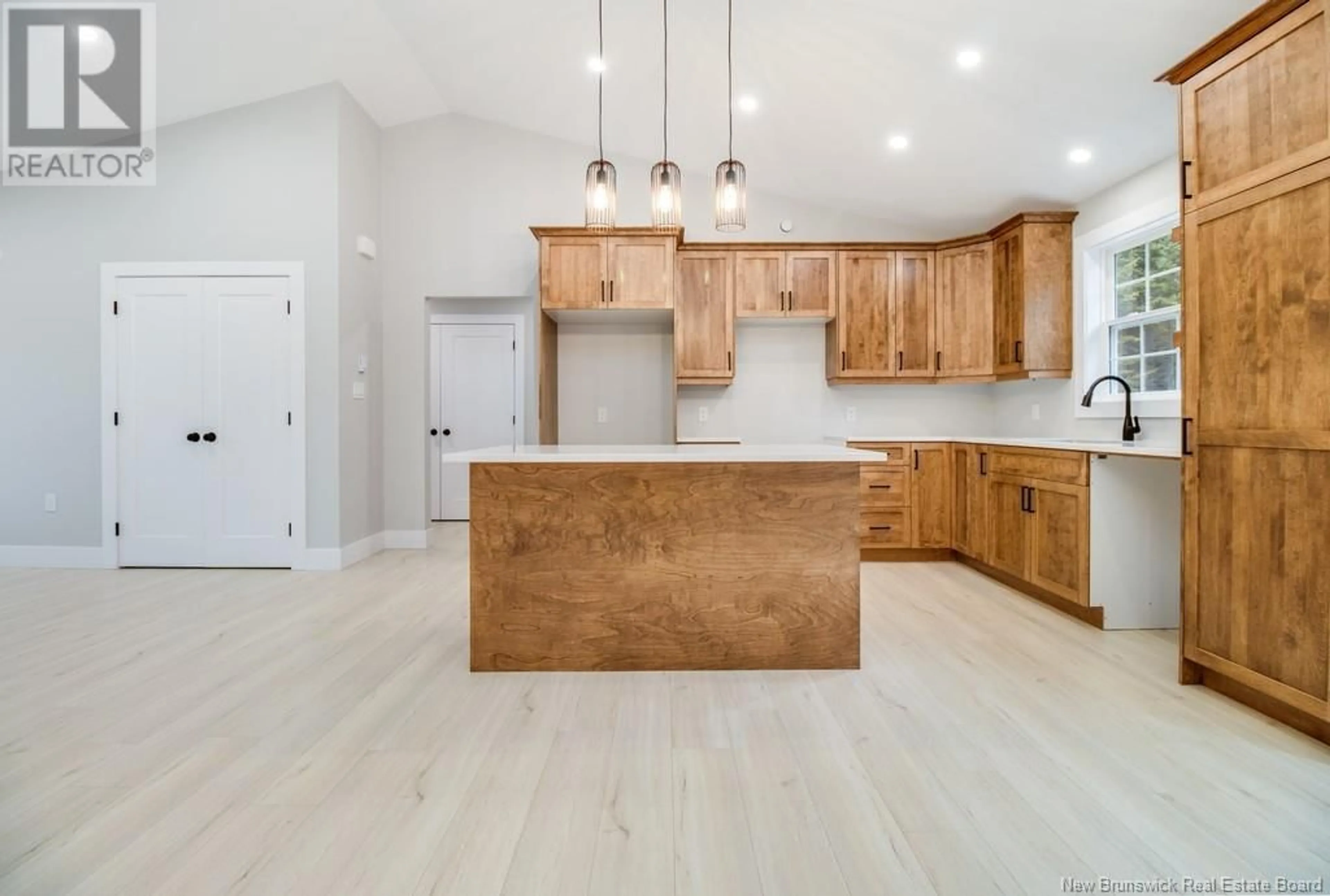 Open concept kitchen, wood/laminate floor for 52 Sandlewood Lane, Douglas New Brunswick E3G0E7