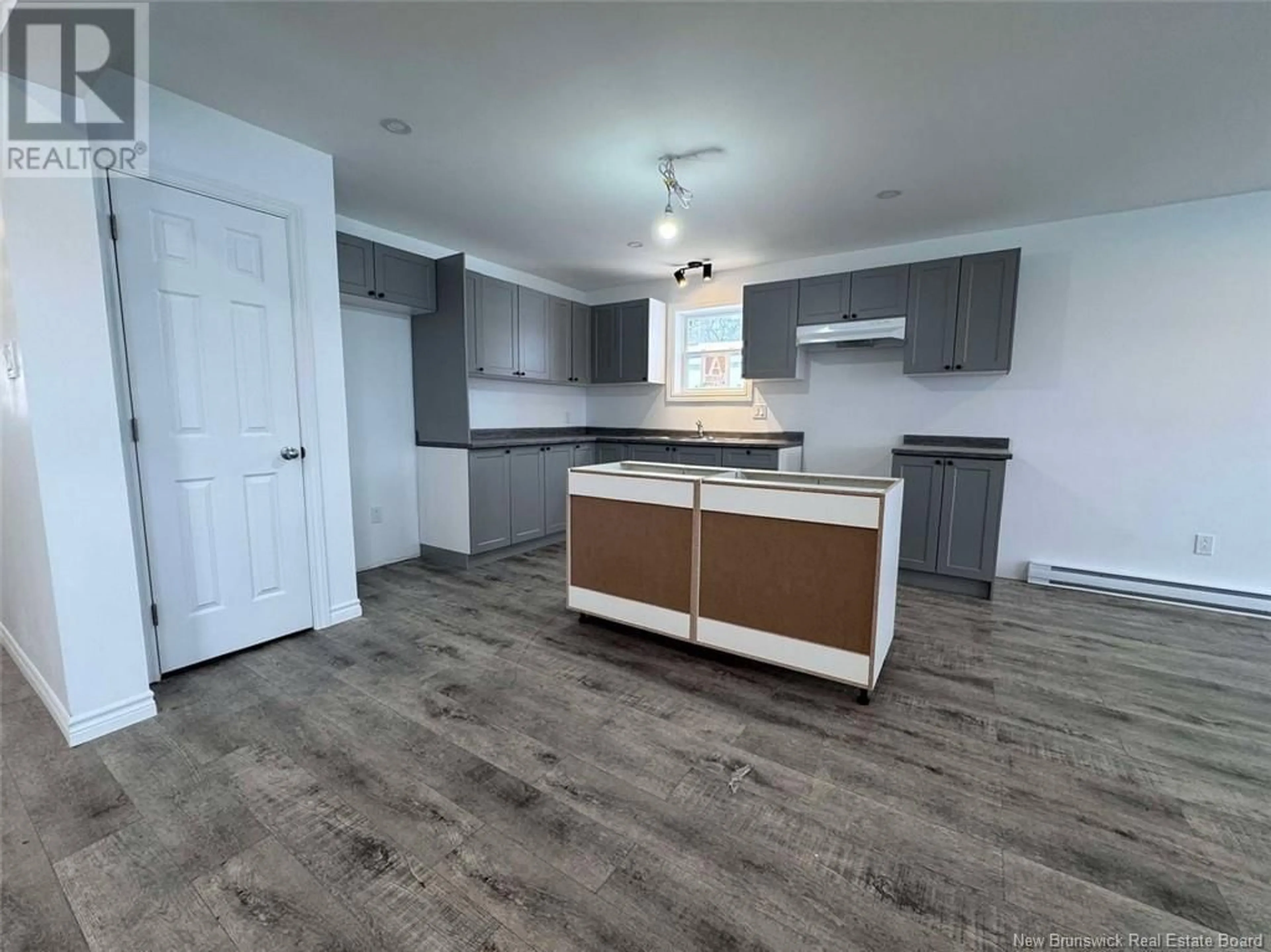 Open concept kitchen, wood/laminate floor for 6 Gagnon Avenue, Edmundston New Brunswick E3V3H8