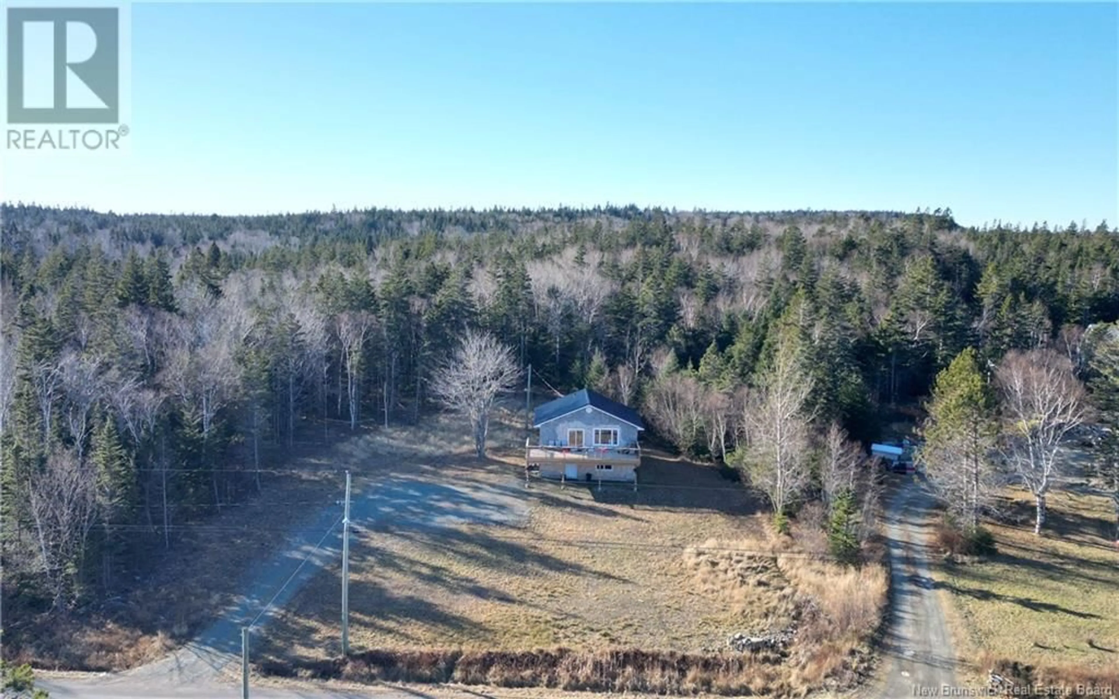 A pic from outside/outdoor area/front of a property/back of a property/a pic from drone, forest/trees view for 235 Whistle Road, Grand Manan New Brunswick E5G1B4