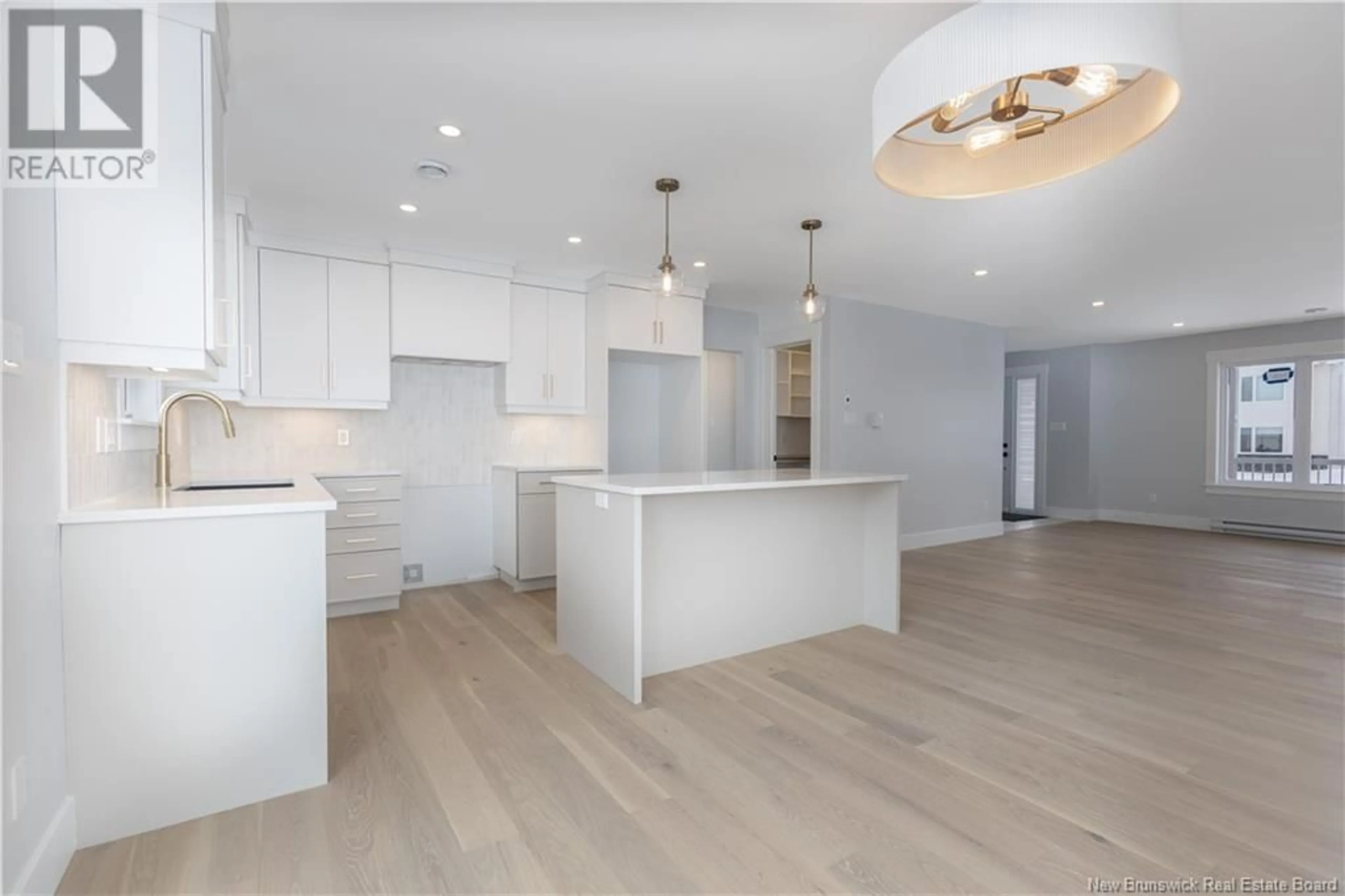 Open concept kitchen, wood/laminate floor for 106 MELBOURNE CRESCENT, Moncton New Brunswick E1E0K5