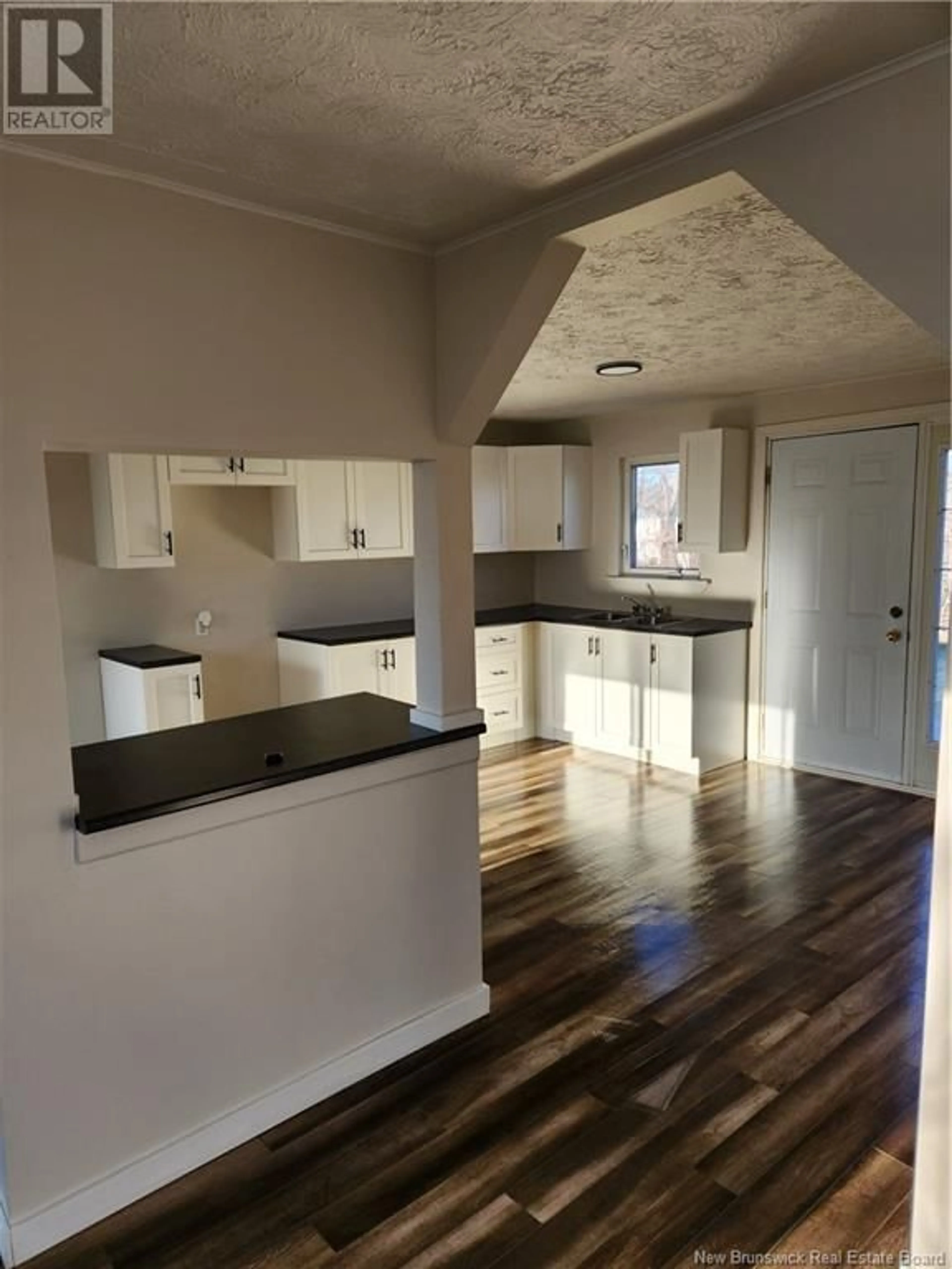 Open concept kitchen, wood/laminate floor for 867 Louis G. Daigle, Tracadie New Brunswick E1X1C2