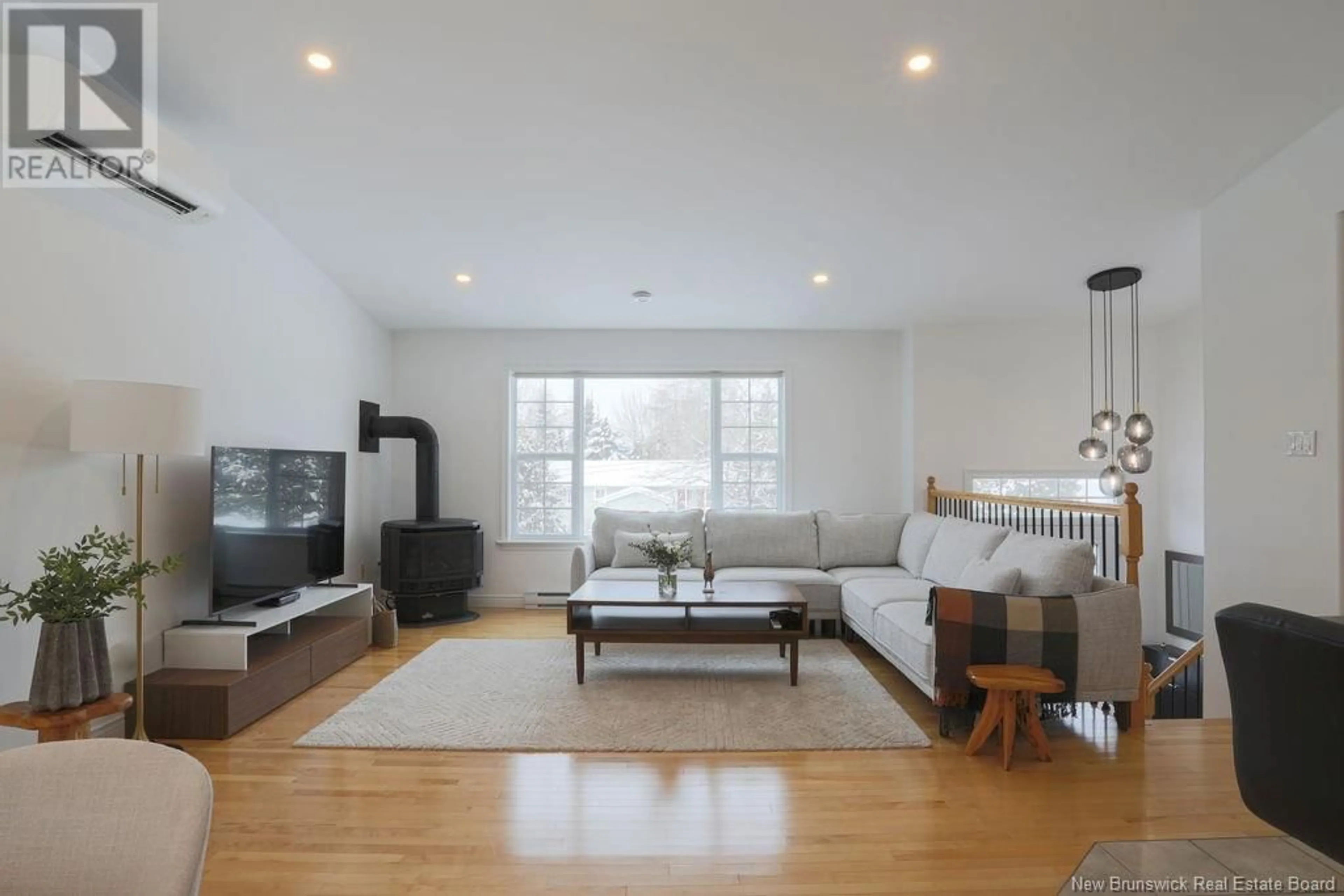 Living room with furniture, wood/laminate floor for 9 Catherine Avenue, Quispamsis New Brunswick E2E4N7