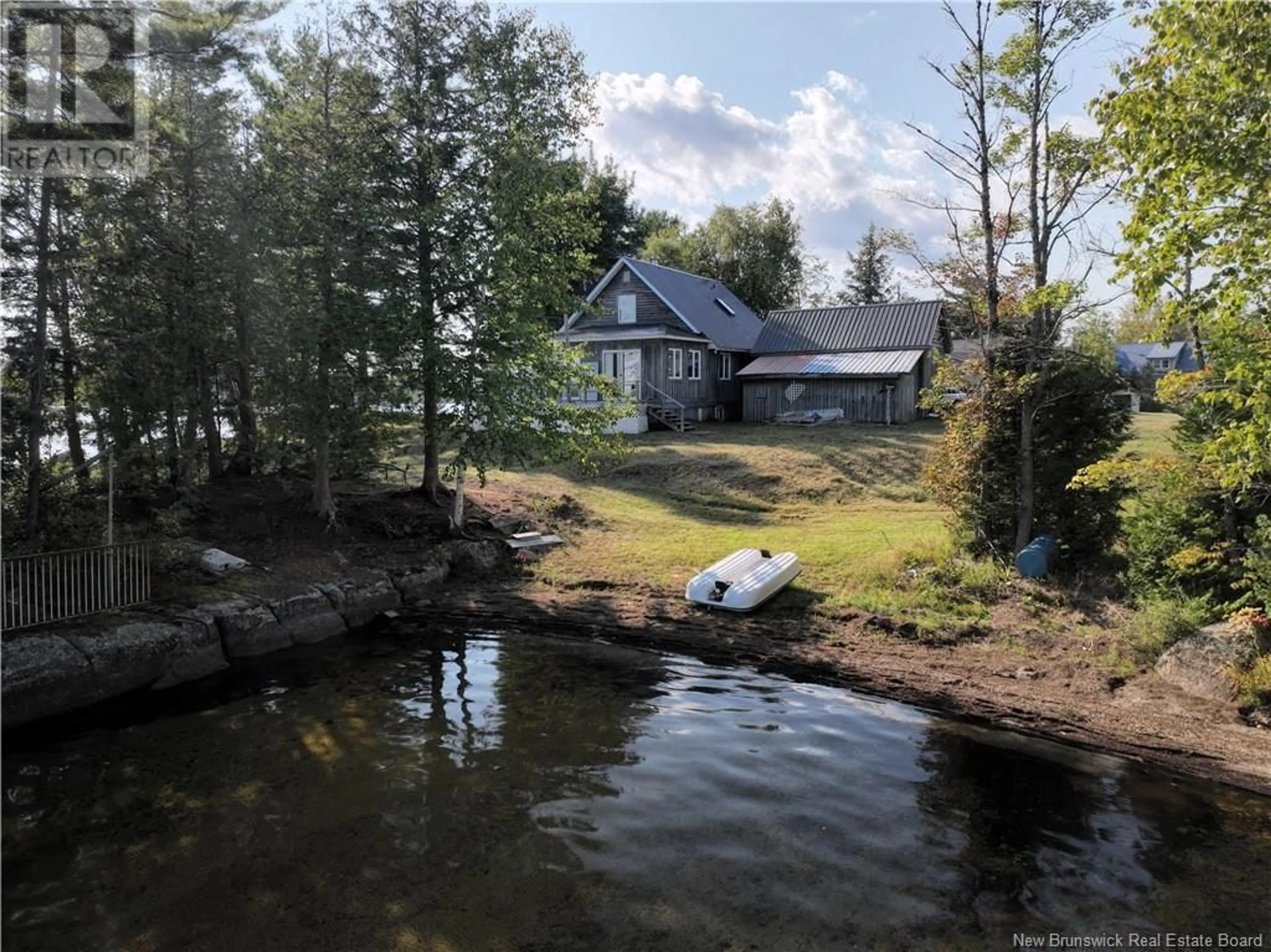 A pic from outside/outdoor area/front of a property/back of a property/a pic from drone, water/lake/river/ocean view for 11 Delong Lane, Second Eel Lake New Brunswick E6H0B5