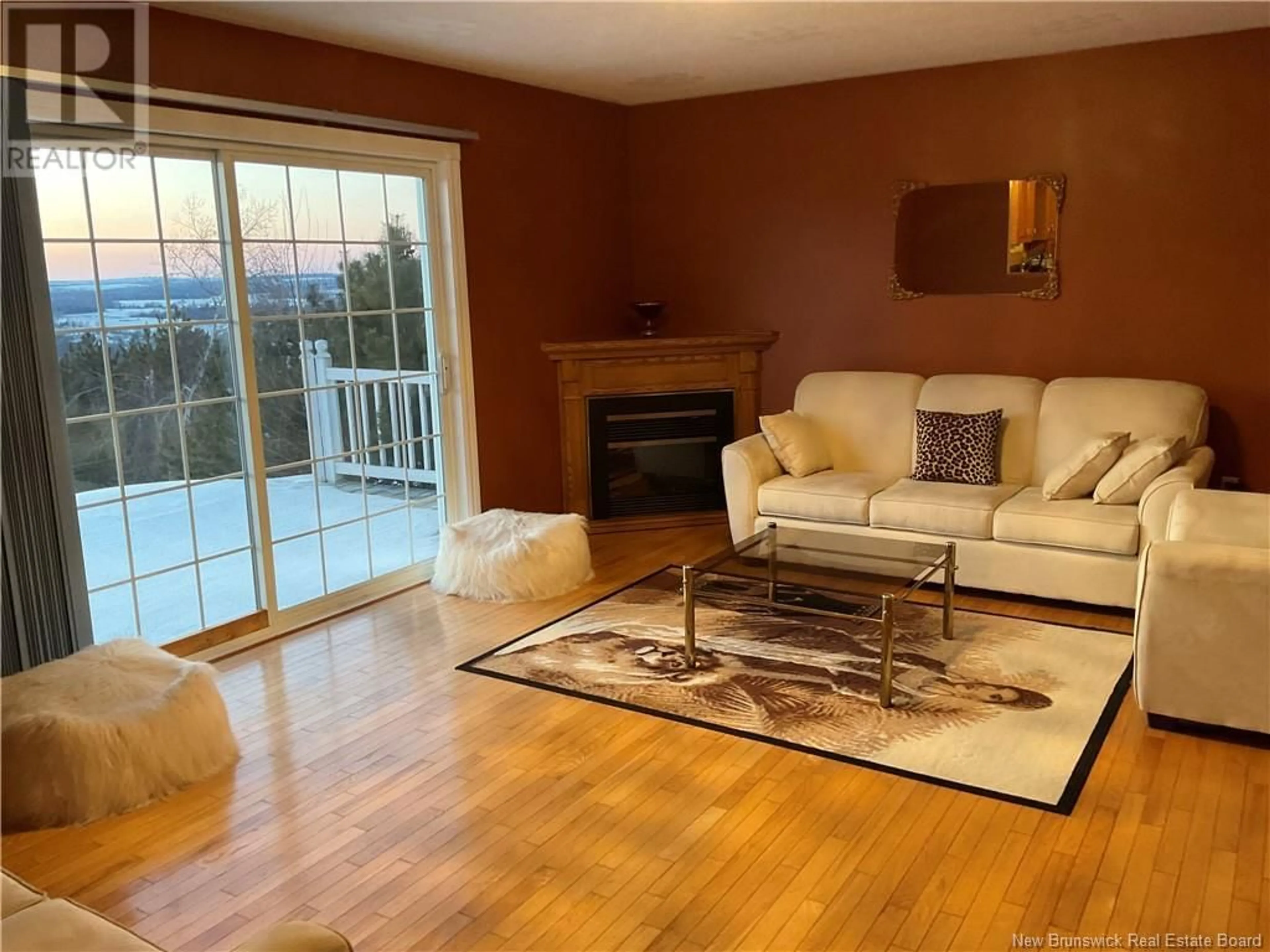 Living room with furniture, wood/laminate floor for 43 Birchwood Drive, Grafton New Brunswick E7N1M7