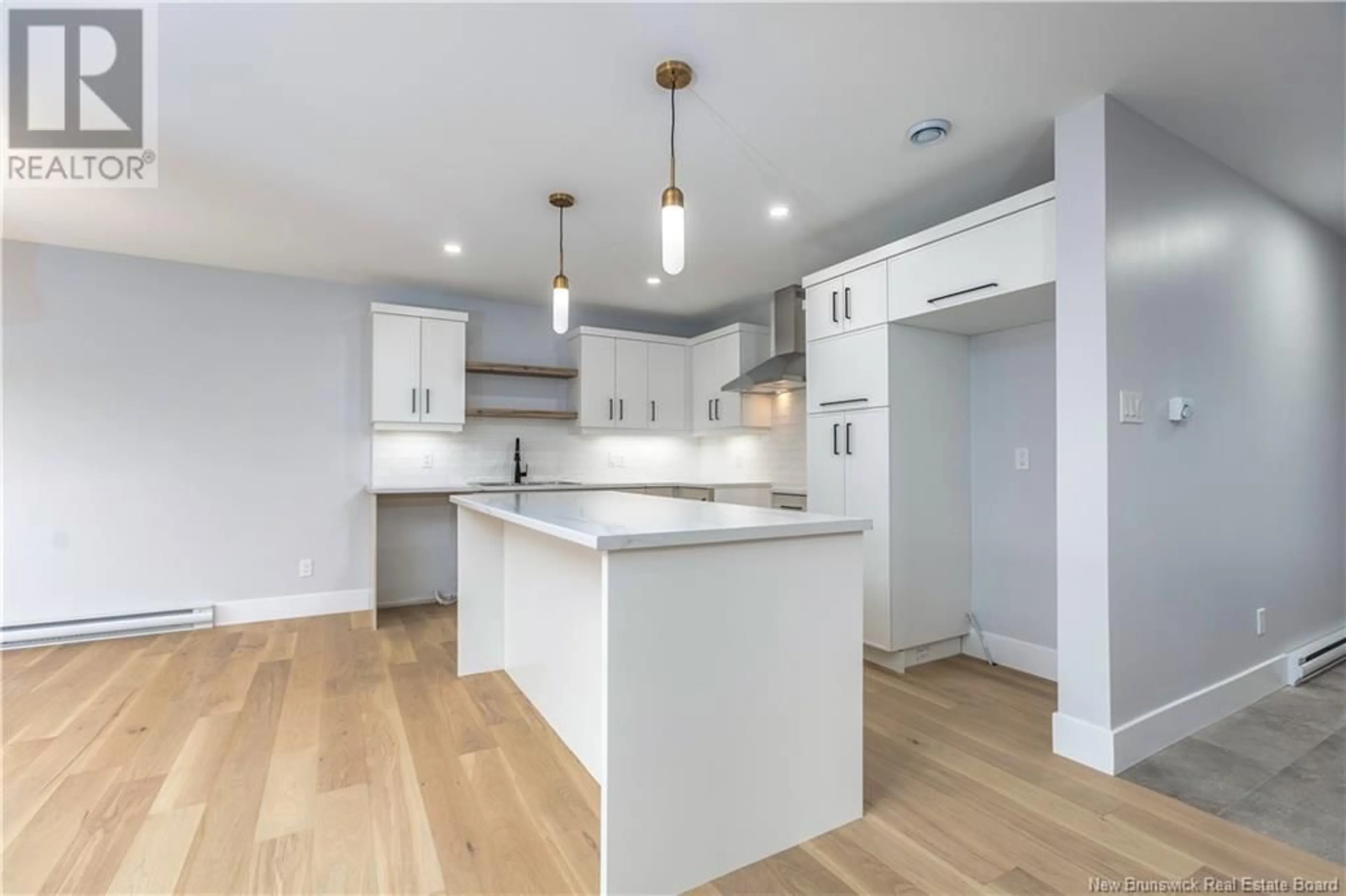 Open concept kitchen, wood/laminate floor for 48 Belfry Street, Moncton New Brunswick E1G5B6