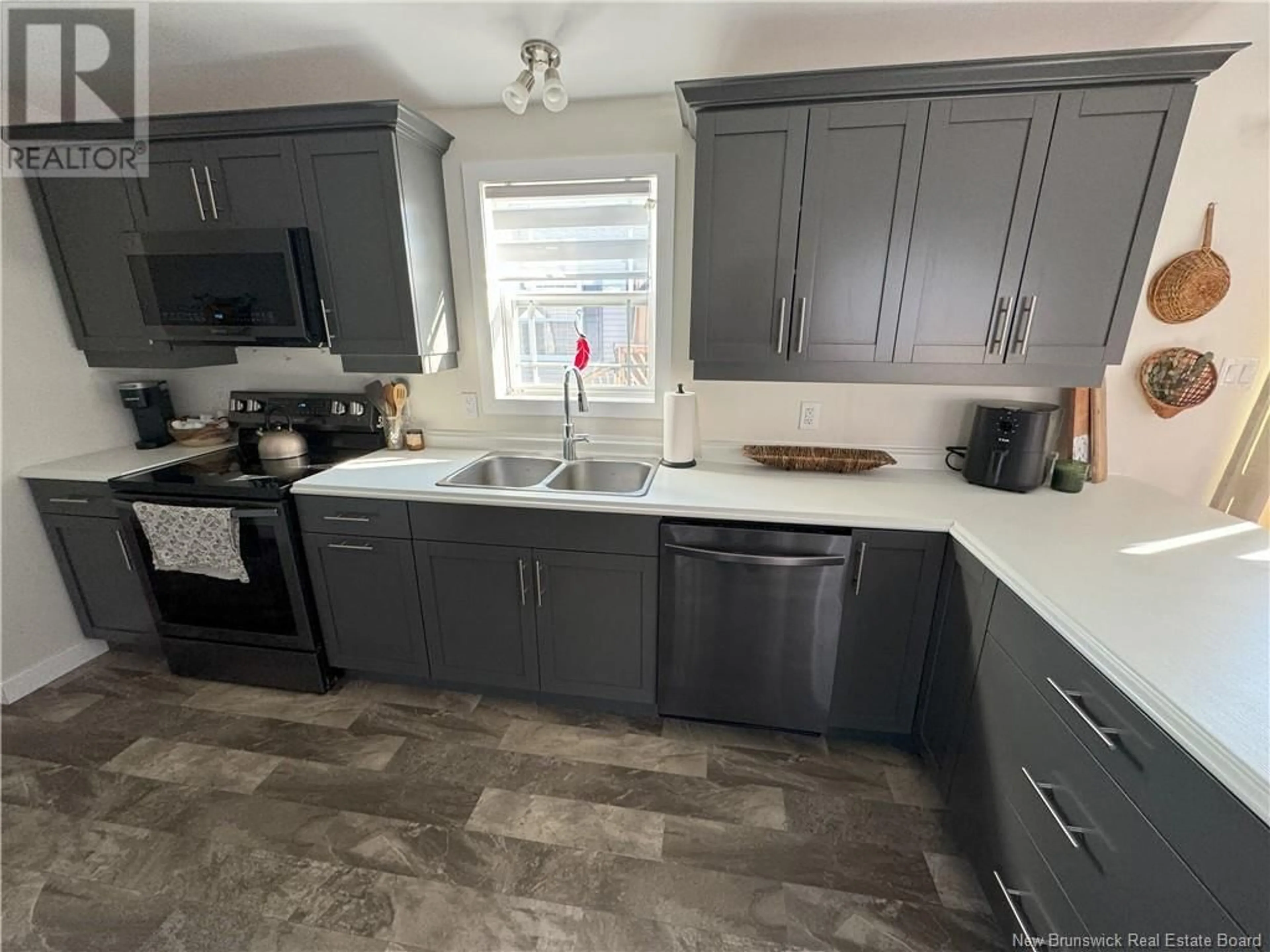 Open concept kitchen, ceramic/tile floor for 43 Ivory Court, Woodstock New Brunswick E7M0G5