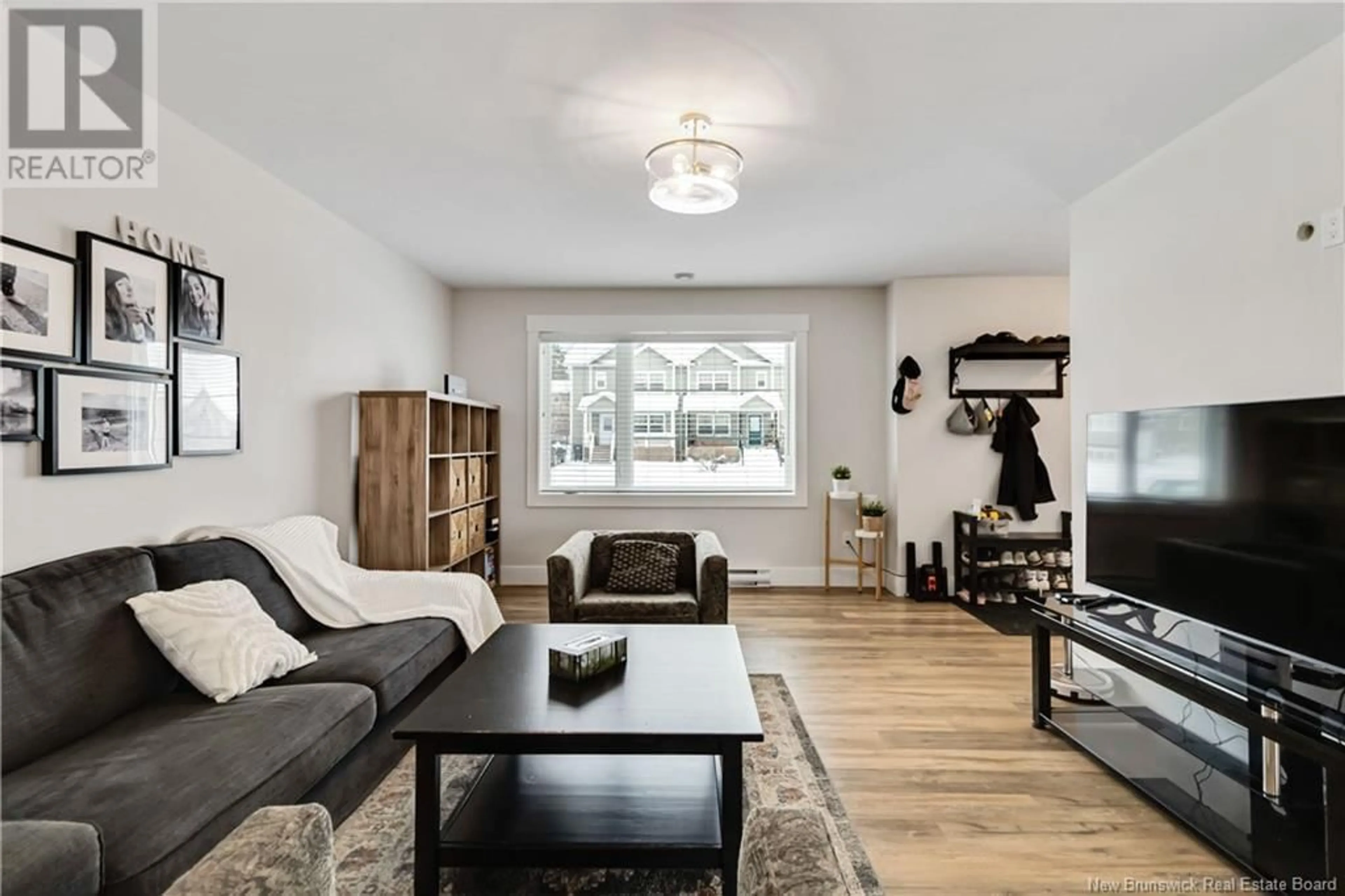 Living room with furniture, wood/laminate floor for 92 Edington Street, Moncton New Brunswick E1E0G6