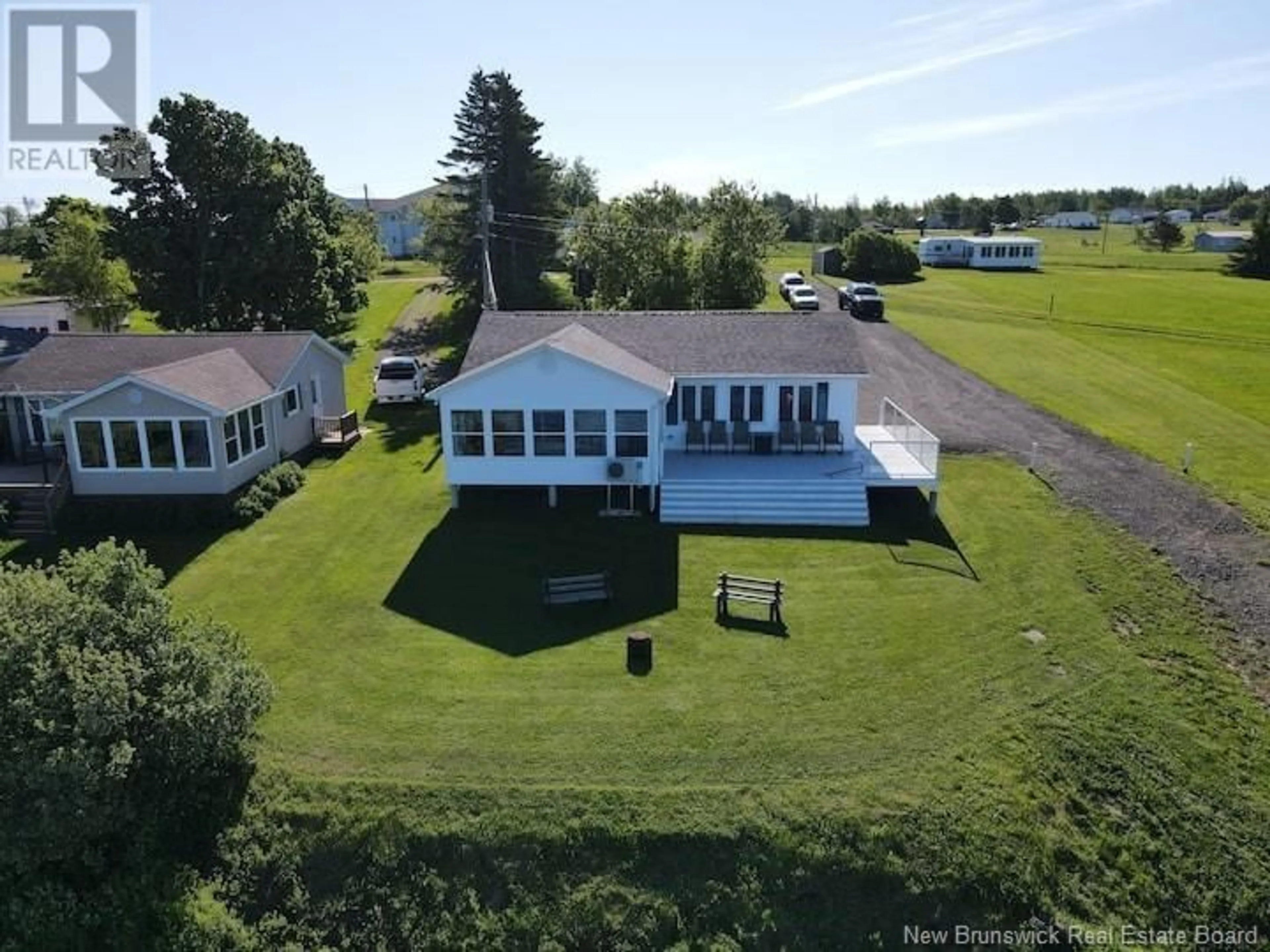 A pic from outside/outdoor area/front of a property/back of a property/a pic from drone, water/lake/river/ocean view for 33 Lionel Road, Bouctouche New Brunswick E4S5L7