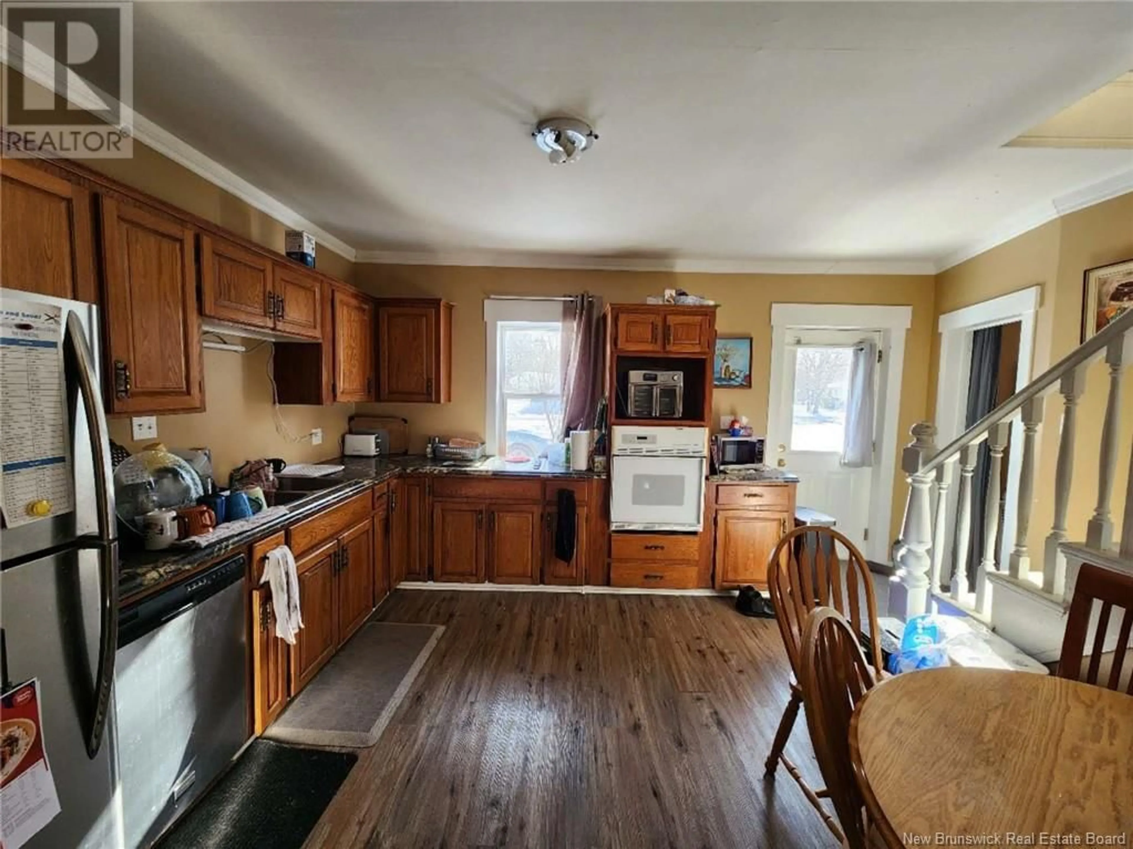 Open concept kitchen, wood/laminate floor for 279 Sunset Drive, Fredericton New Brunswick E3A1B1