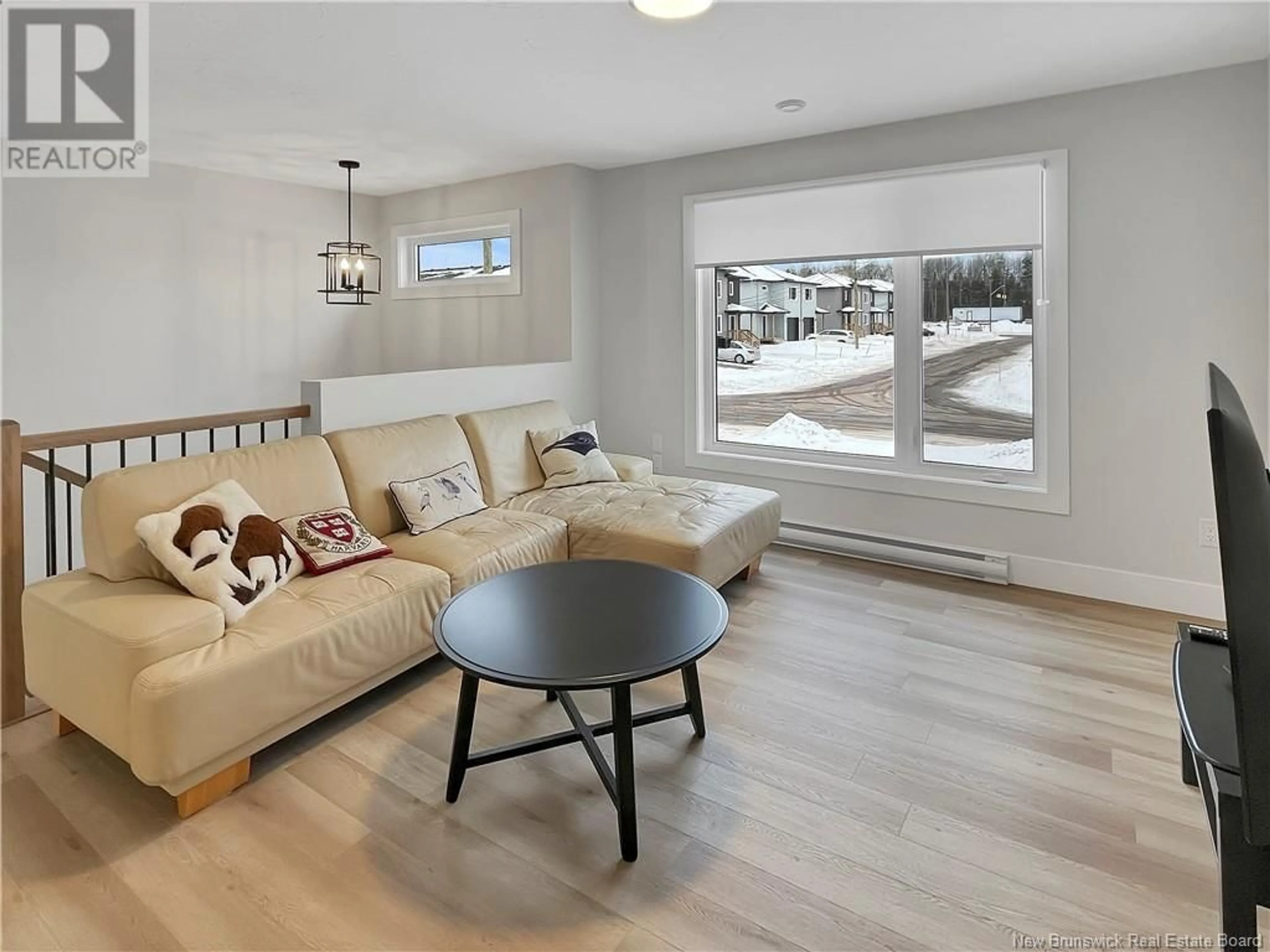 Living room with furniture, wood/laminate floor for 70 Delta Street, Dieppe New Brunswick E1K0A4