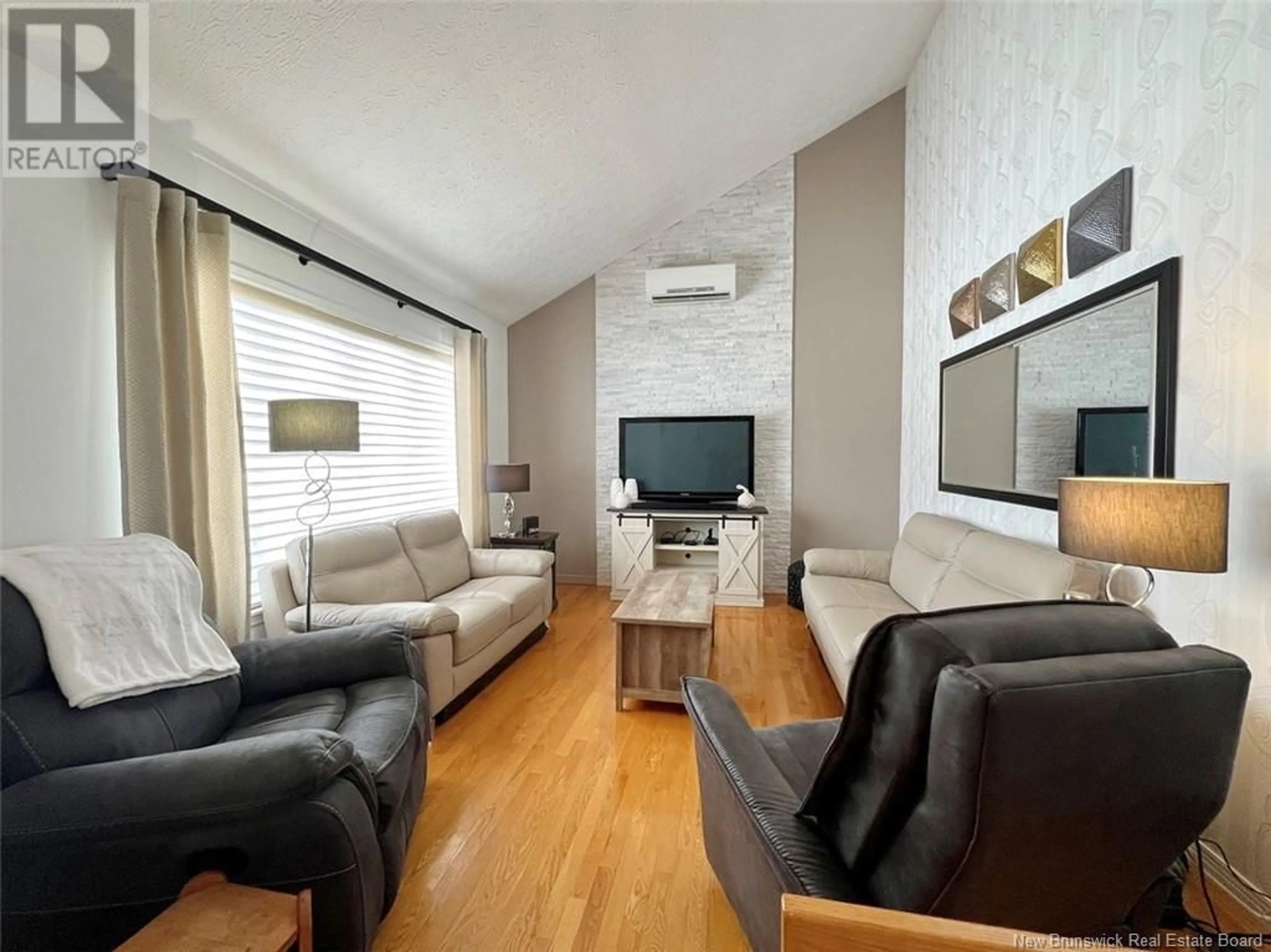 Living room with furniture, wood/laminate floor for 33 BREAU AVENUE, Edmundston New Brunswick E3V3Z4