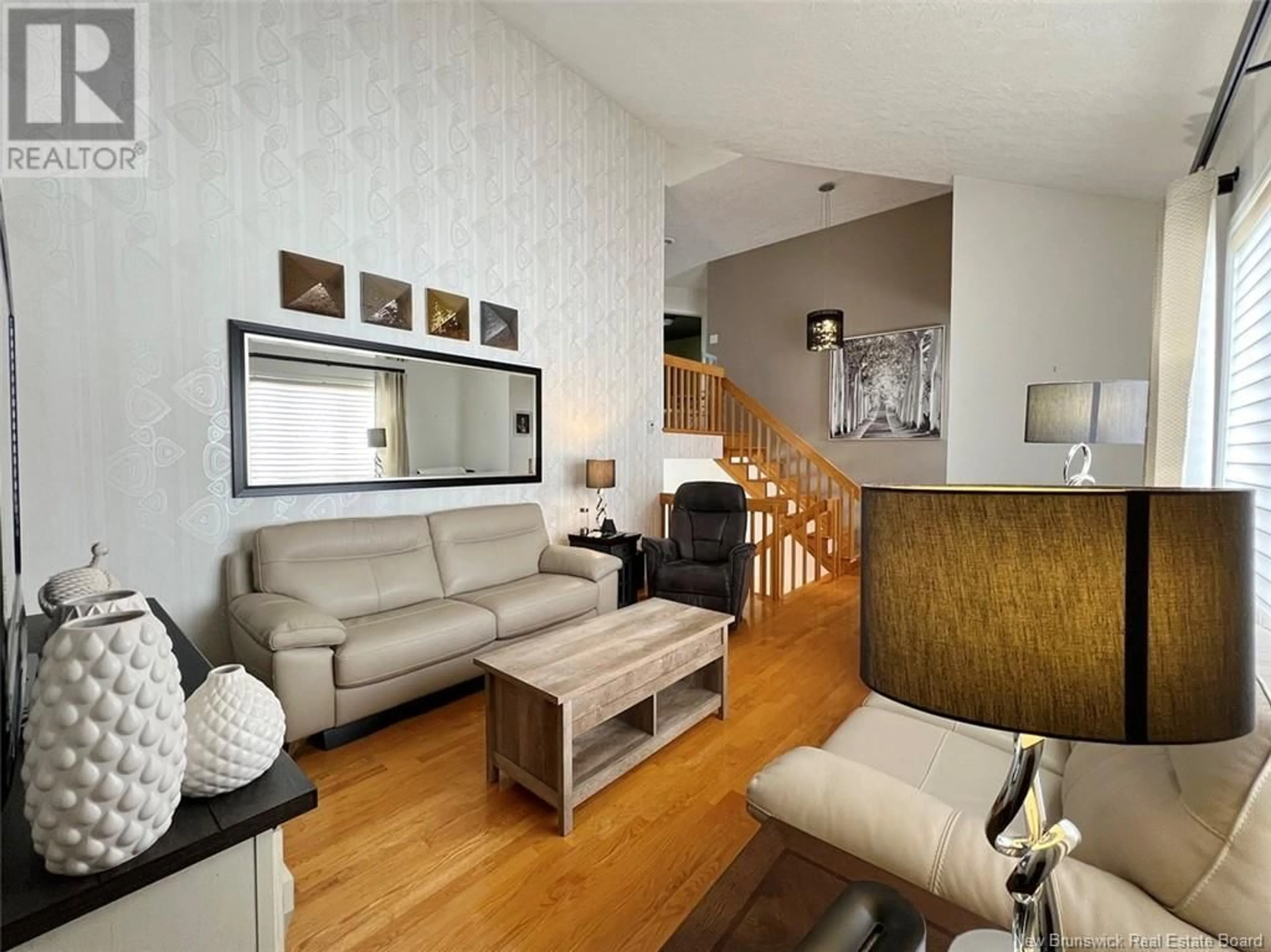 Living room with furniture, wood/laminate floor for 33 BREAU AVENUE, Edmundston New Brunswick E3V3Z4