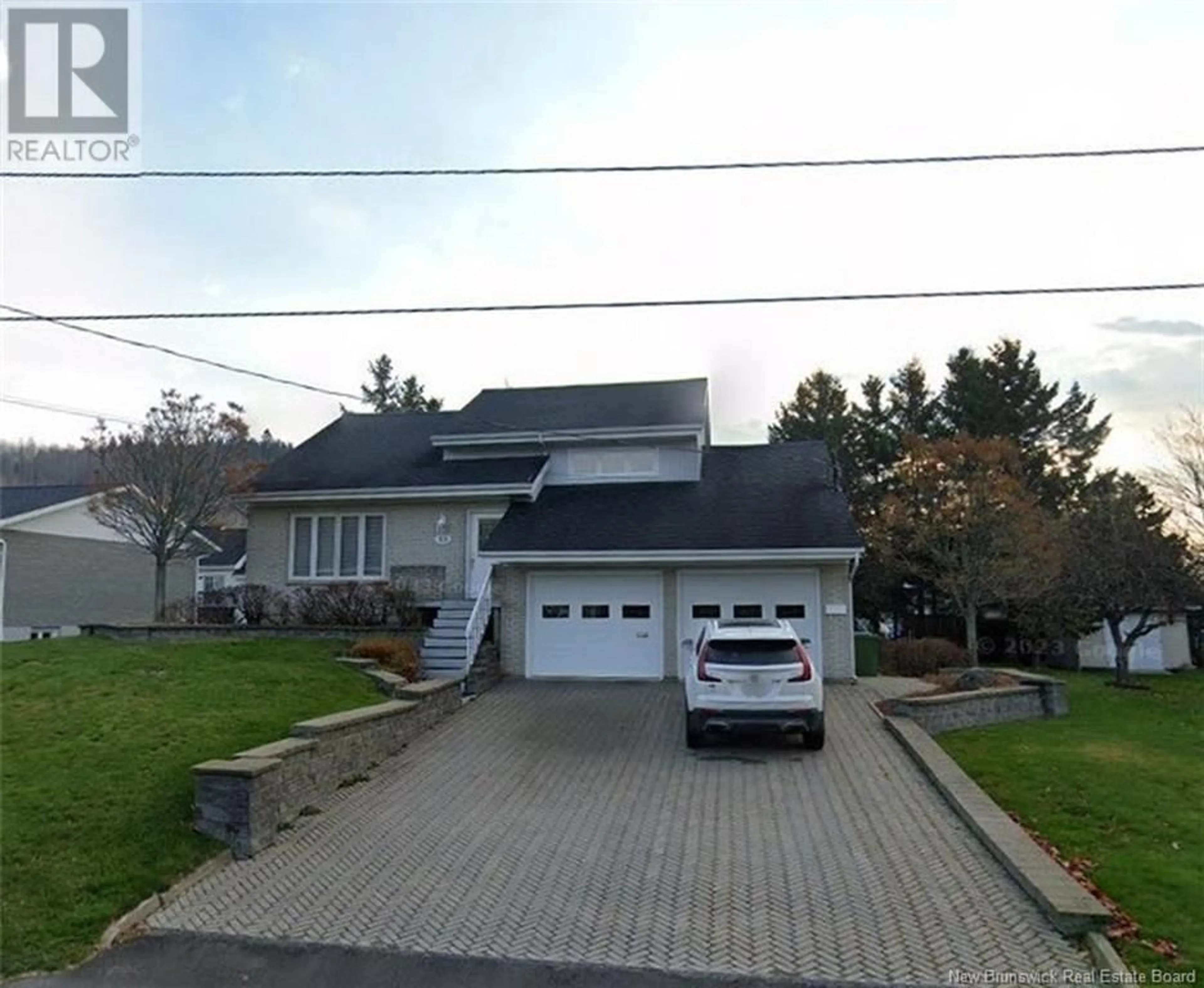 A pic from outside/outdoor area/front of a property/back of a property/a pic from drone, street for 33 Breau Avenue, Edmundston New Brunswick E3V3Z4