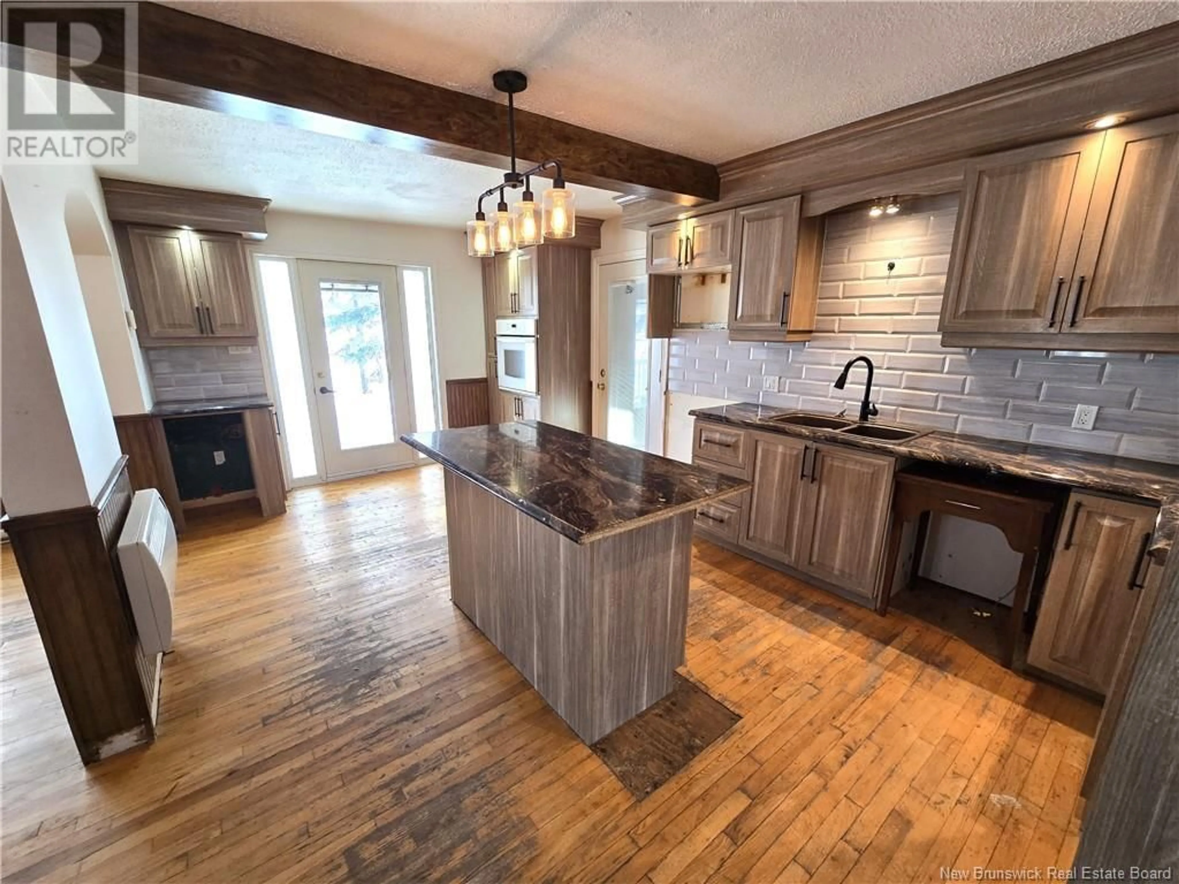 Open concept kitchen, wood/laminate floor for 13850 144 Route, Rivière-Verte New Brunswick E7C3B6