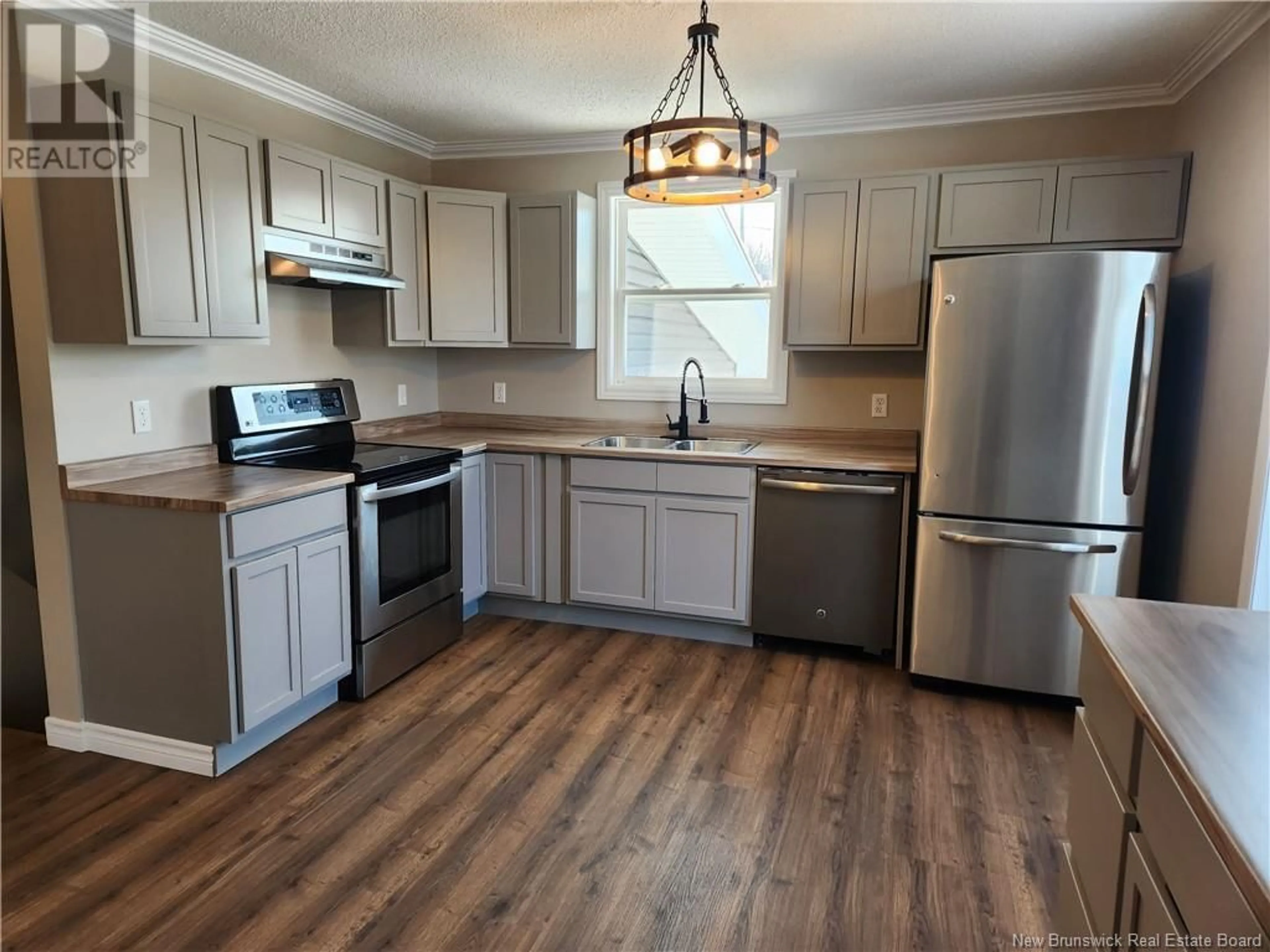 Open concept kitchen, wood/laminate floor for 57 McCluskey Terrace, Grand Falls New Brunswick E3Y1E1