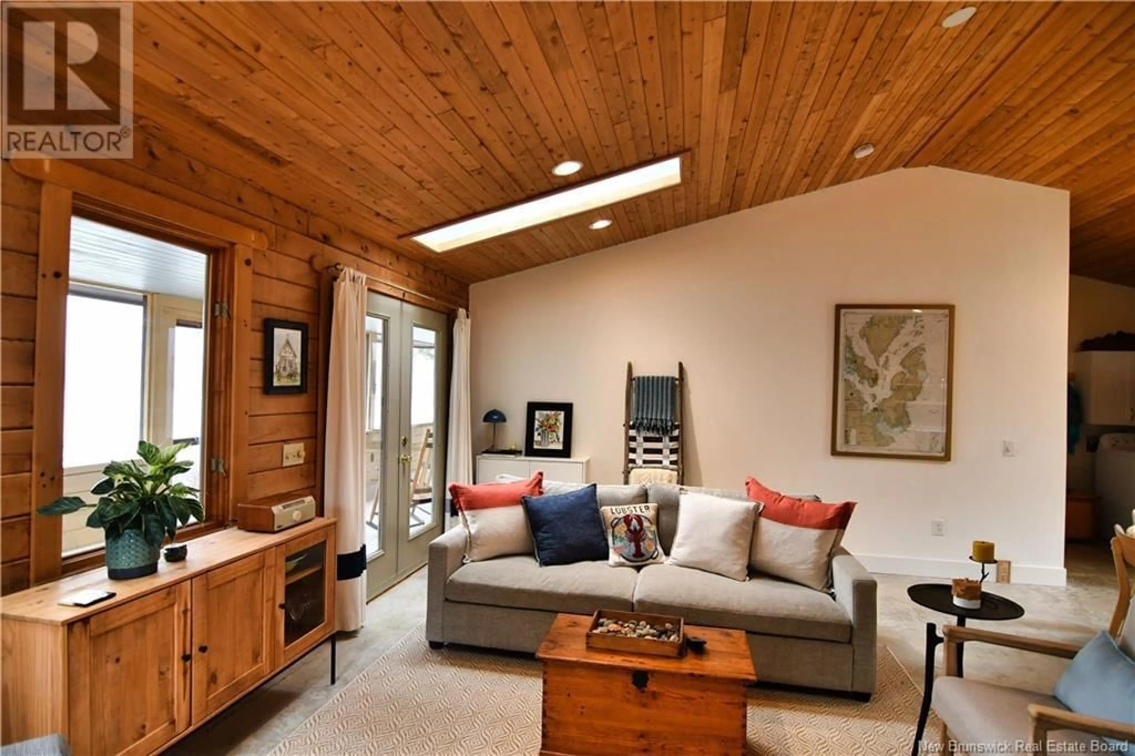 Living room with furniture, wood/laminate floor for 61 CIRCLE DRIVE, Welshpool New Brunswick E5E1Z8