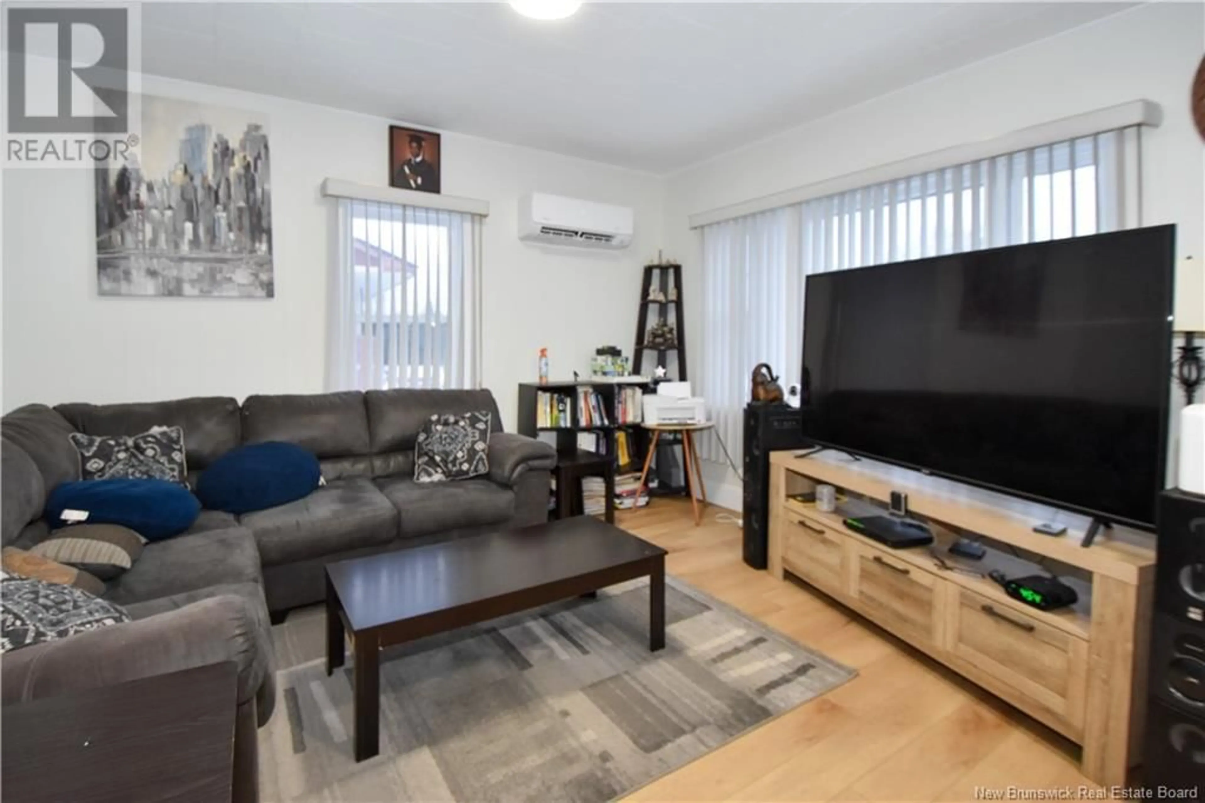 Living room with furniture, wood/laminate floor for 862 Louis G. Daigle, Tracadie New Brunswick E1X1C2