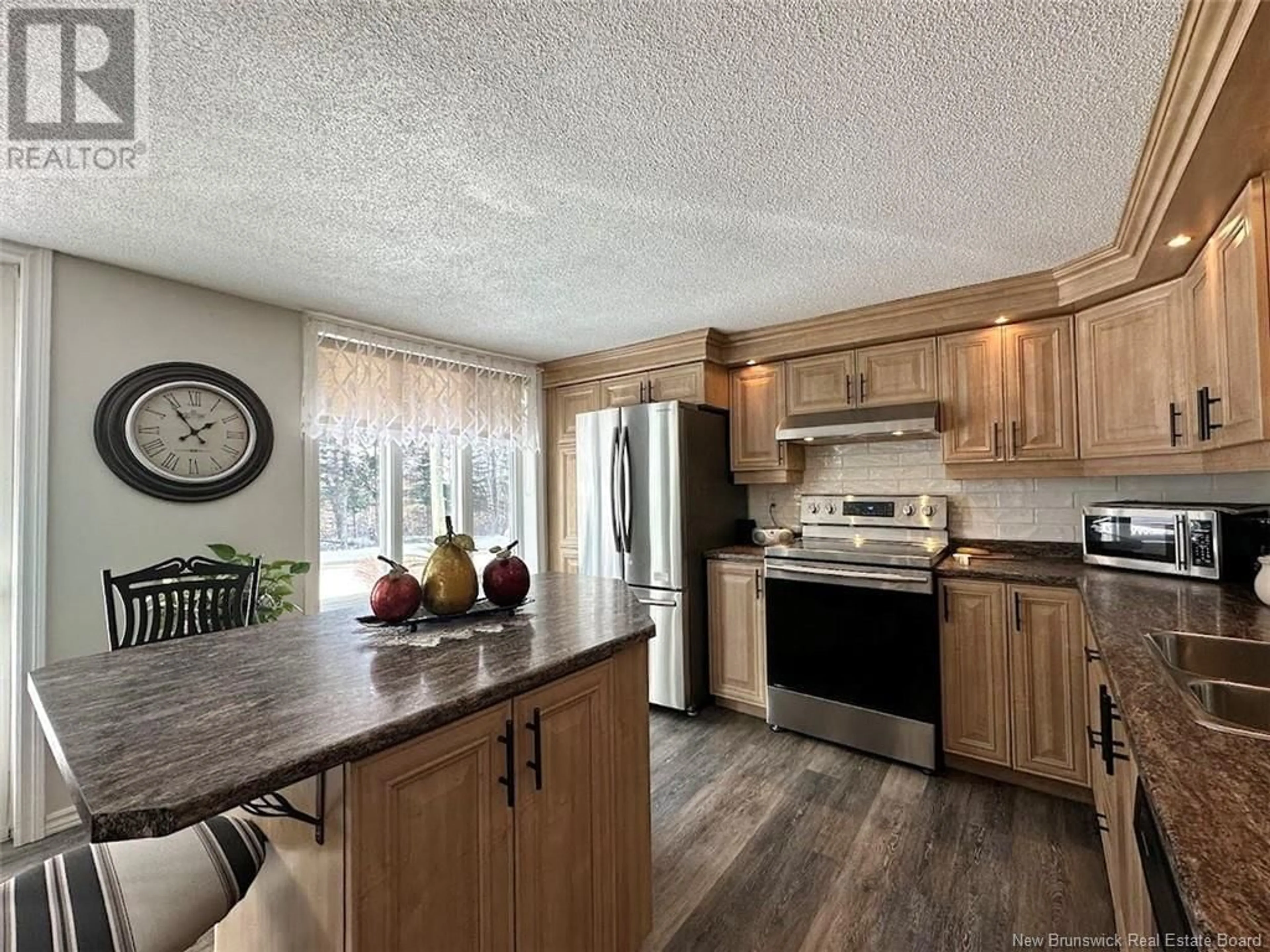 Open concept kitchen, wood/laminate floor for 125 Riviere-Verte Road, Rivière-Verte New Brunswick E7C3A1