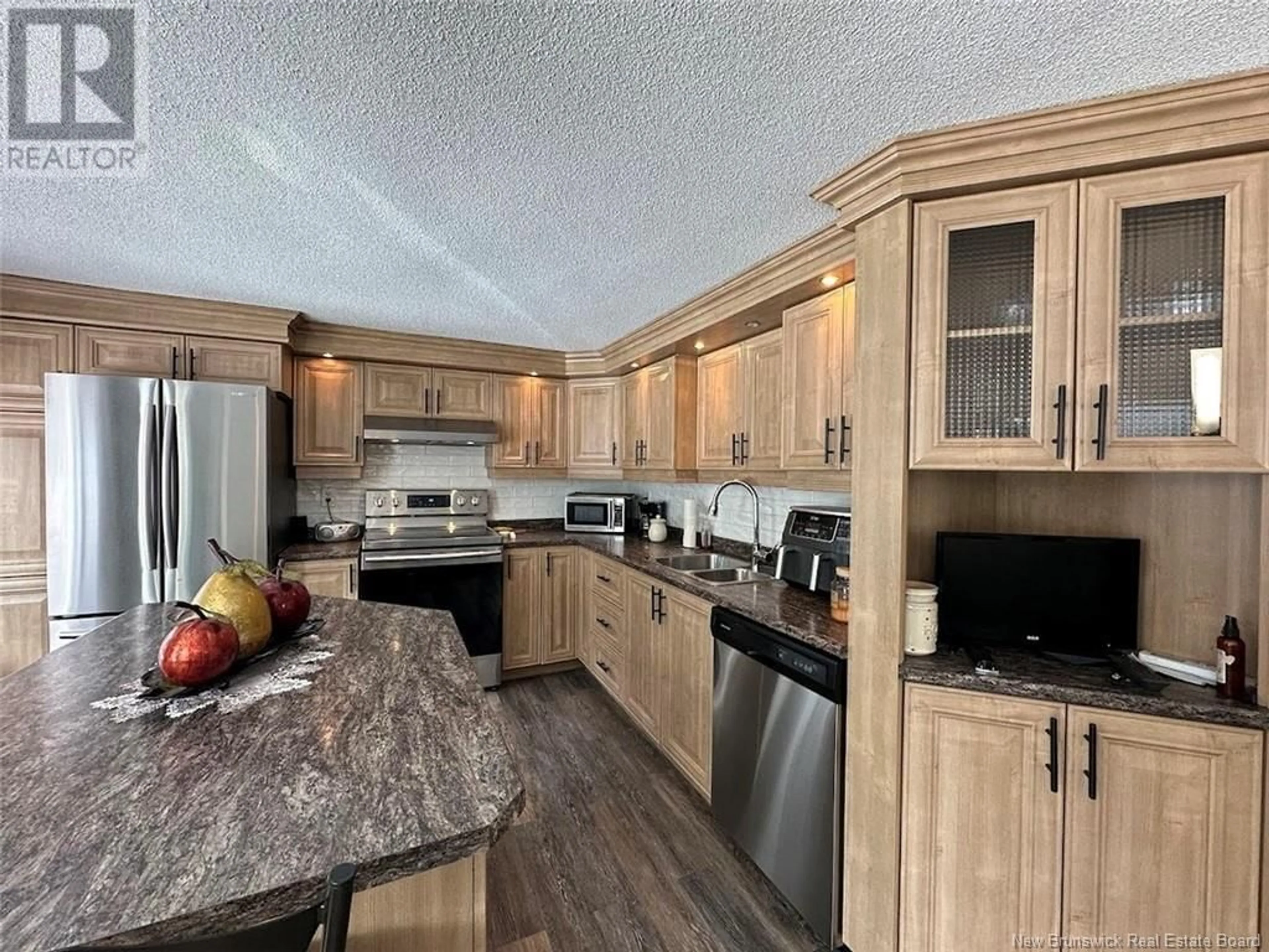 Open concept kitchen, wood/laminate floor for 125 Riviere-Verte Road, Rivière-Verte New Brunswick E7C3A1