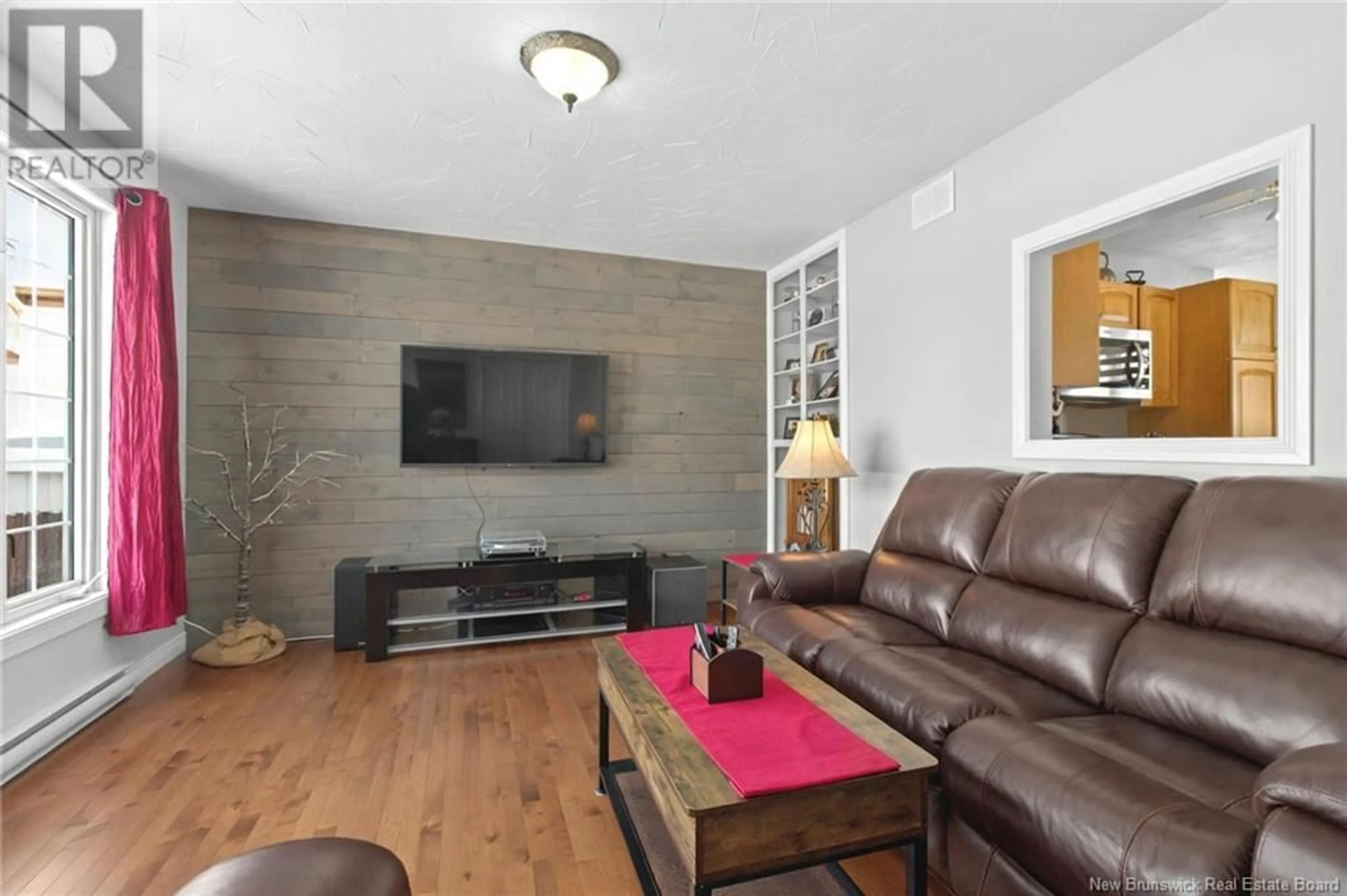 Living room with furniture, wood/laminate floor for 500 Champlain Street, Dieppe New Brunswick E1A1P4