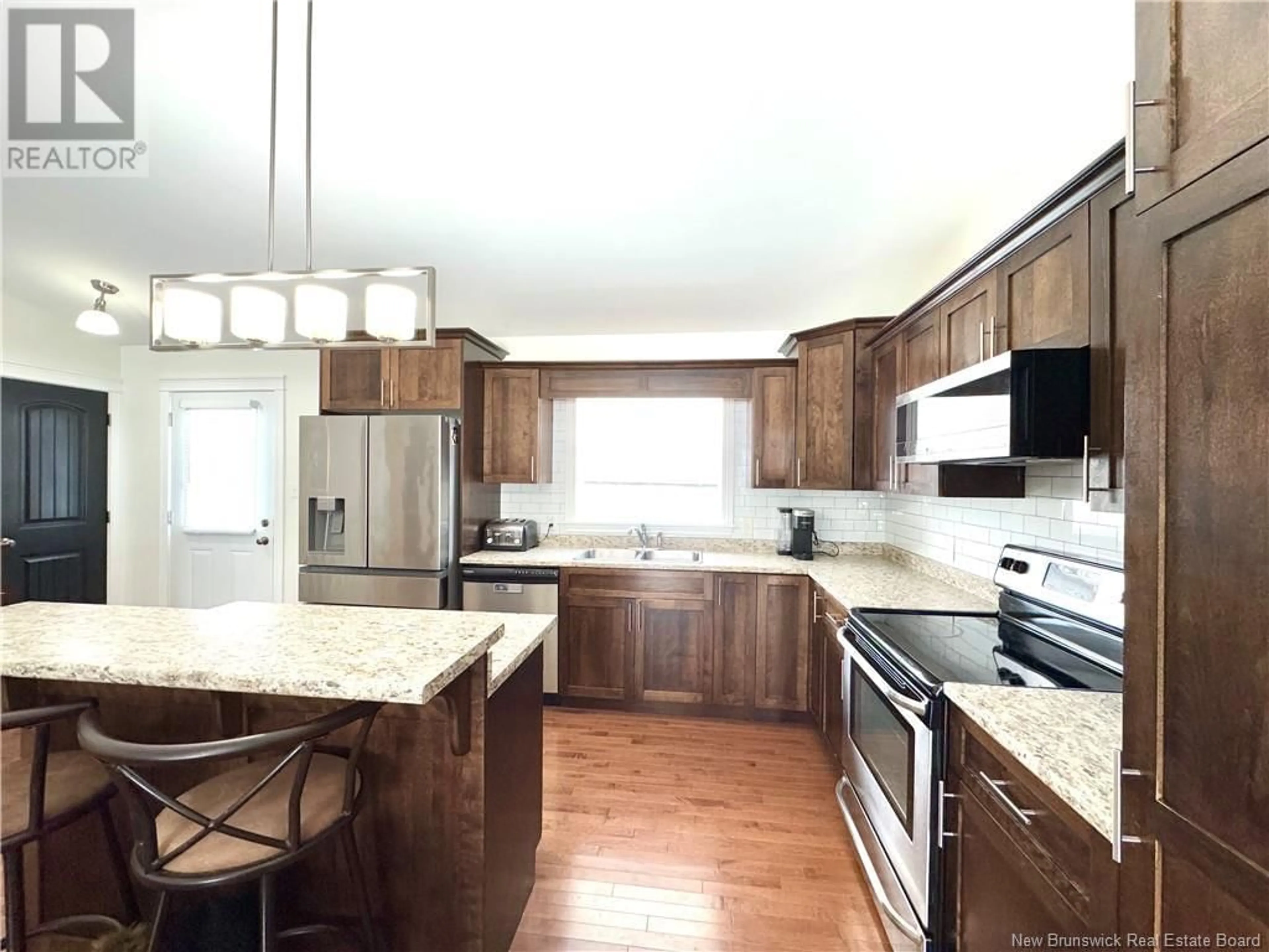 Open concept kitchen, wood/laminate floor for 57 Hollynorth Street, Fredericton New Brunswick E3G0B7