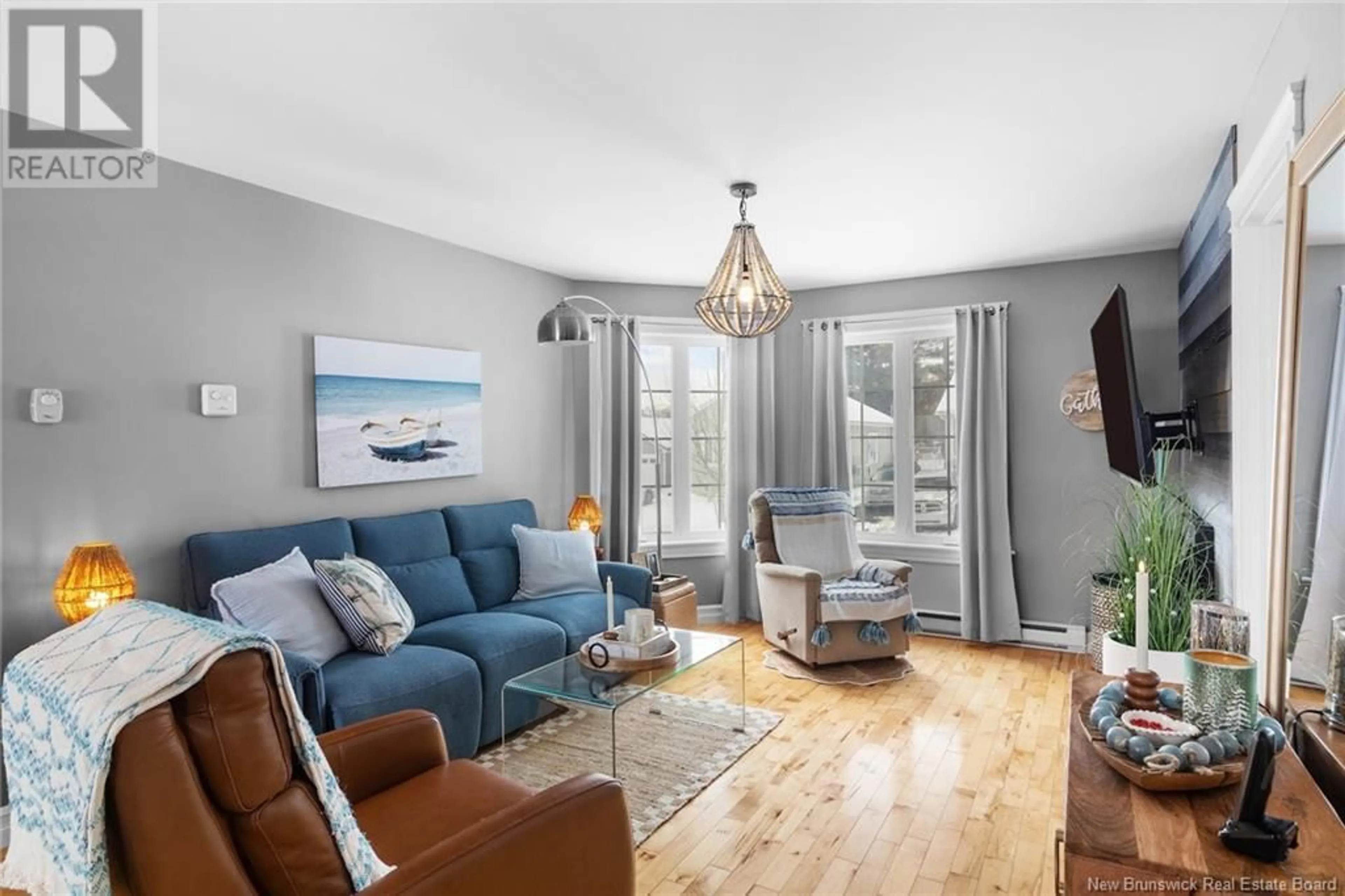 Living room with furniture, wood/laminate floor for 63 Brandon Court, Fredericton New Brunswick E3G0X5