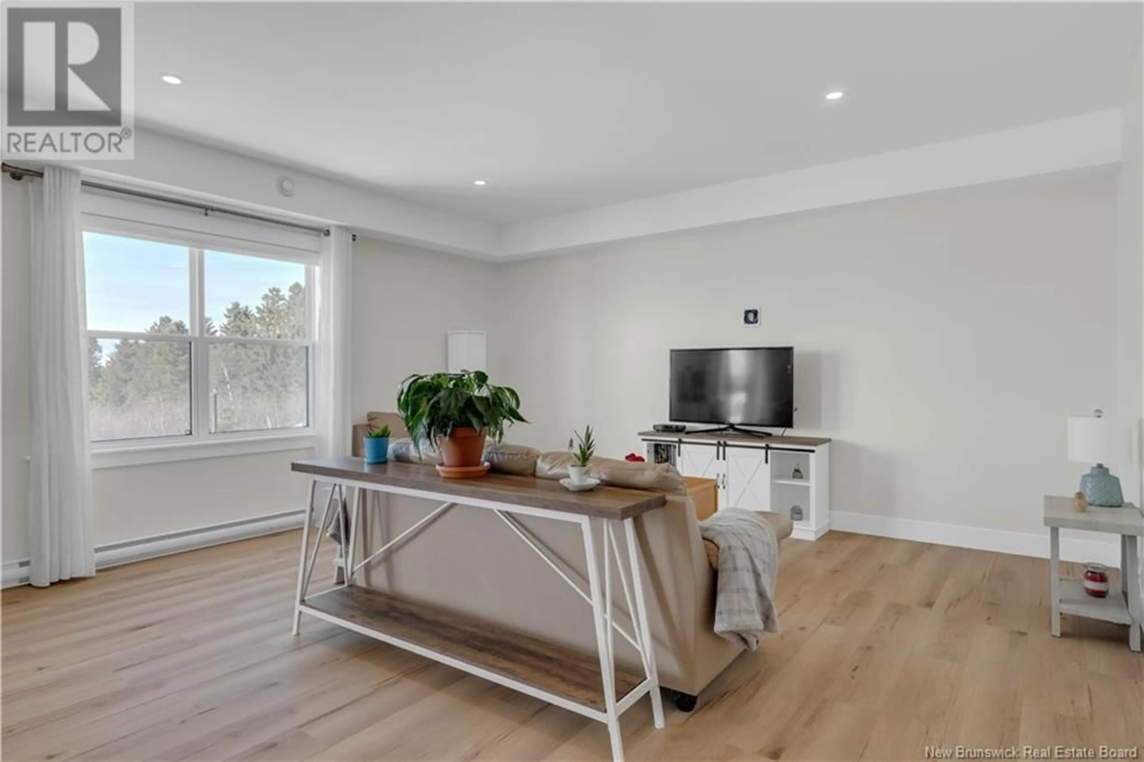 Living room with furniture, wood/laminate floor for 202 - 79 MAPLEVIEW DRIVE, Hampton New Brunswick E5N0A6