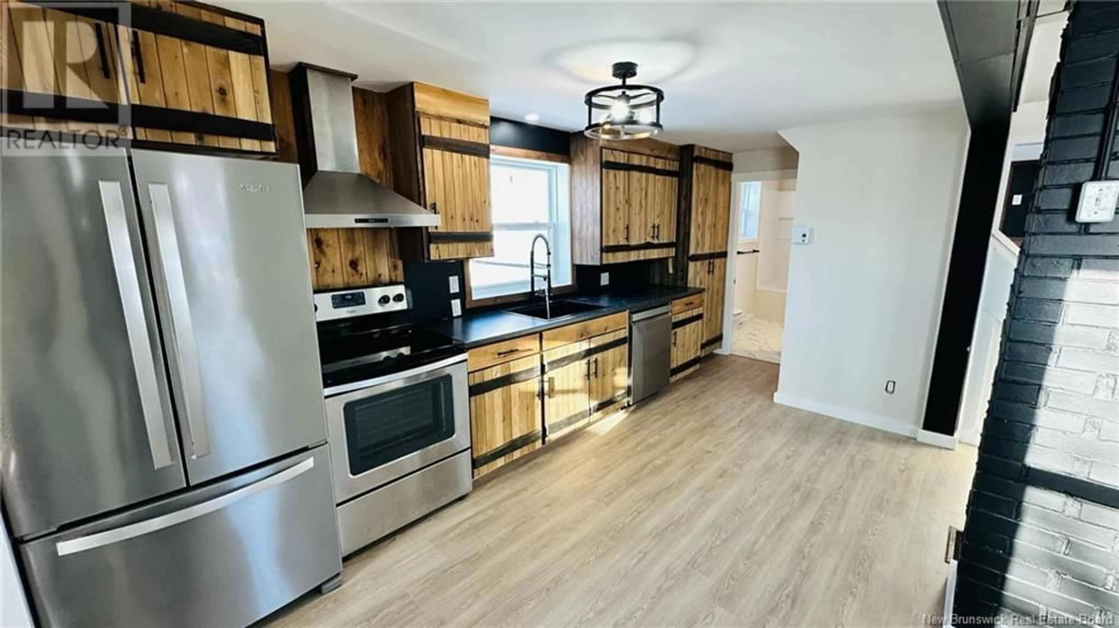 Open concept kitchen, wood/laminate floor for 5642 Rue des Erables, Rogersville New Brunswick E4Y1K7