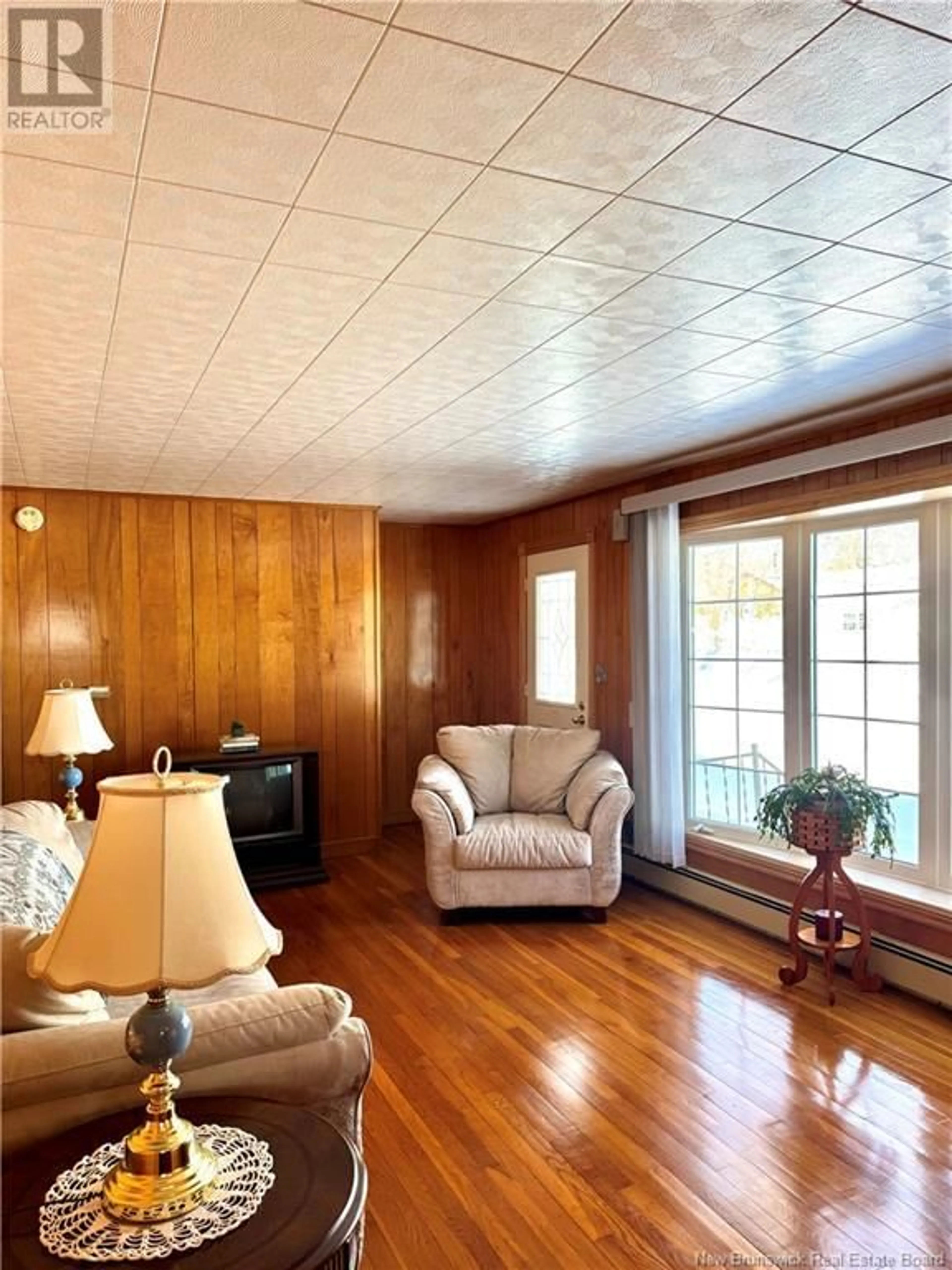 Living room with furniture, wood/laminate floor for 315 Ramsay Street, Miramichi New Brunswick E1V2C7