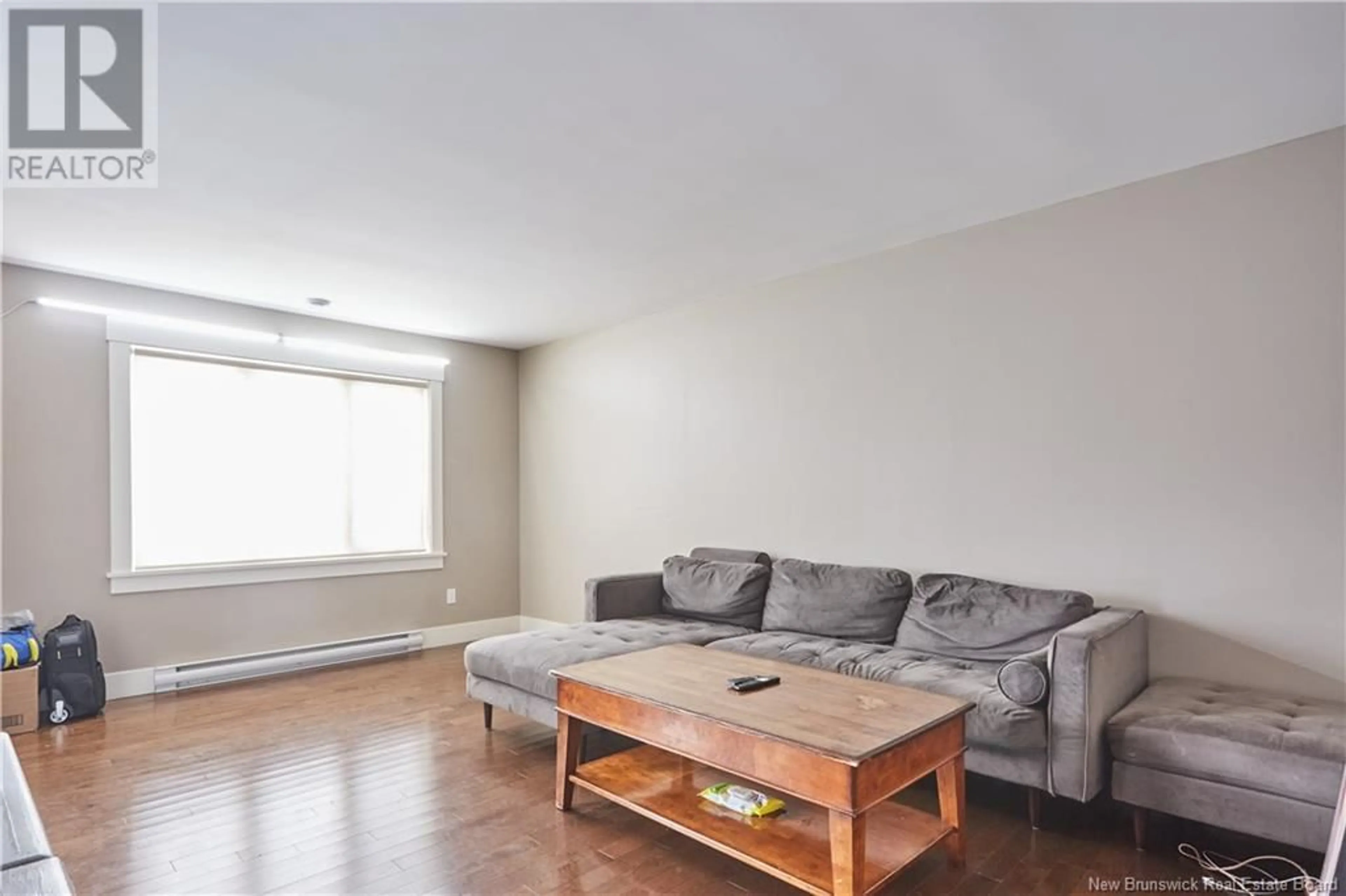 Living room with furniture, wood/laminate floor for 203 SURETTE STREET, Dieppe New Brunswick E1A9R3