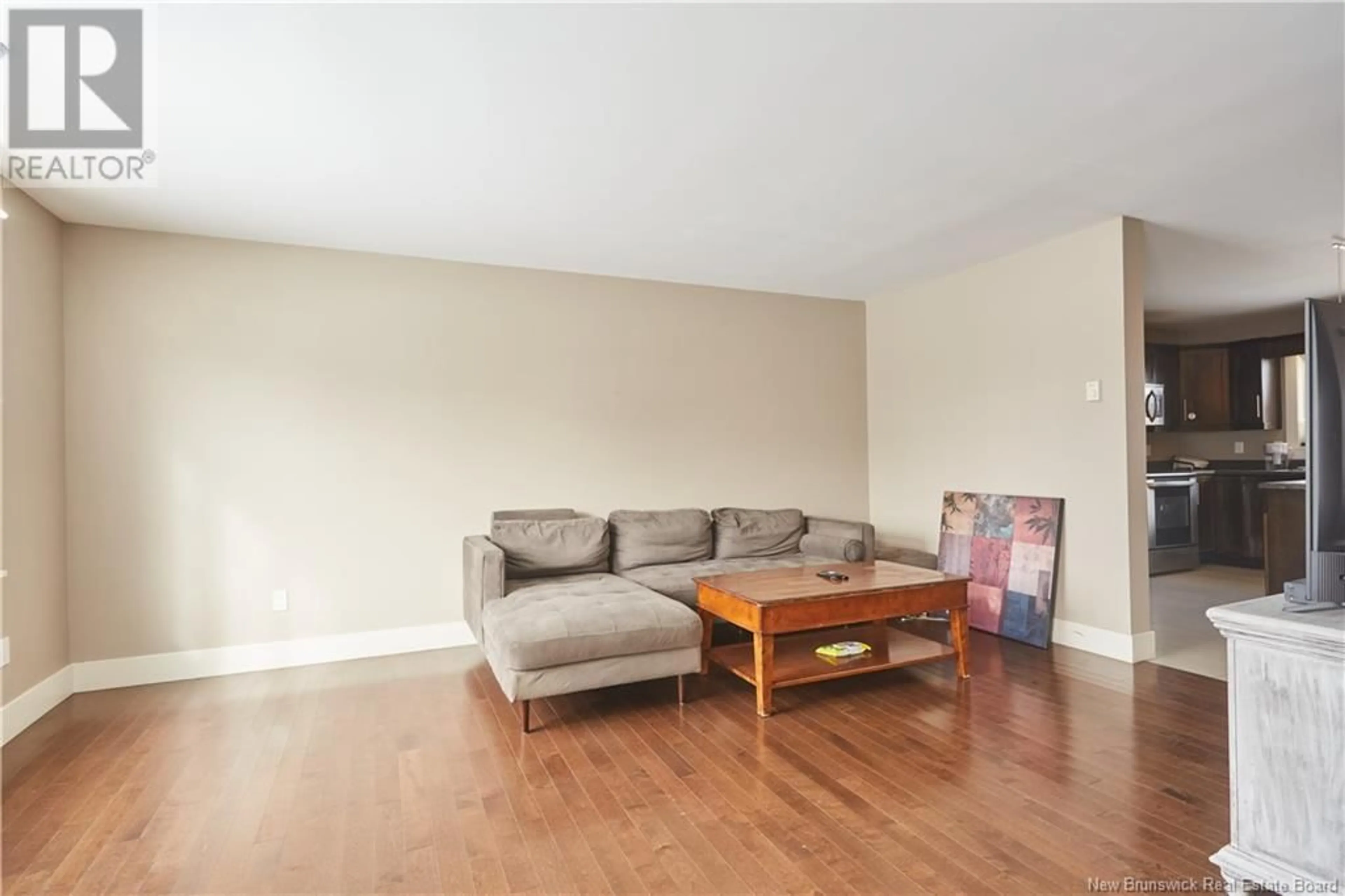 Living room with furniture, wood/laminate floor for 203 SURETTE STREET, Dieppe New Brunswick E1A9R3