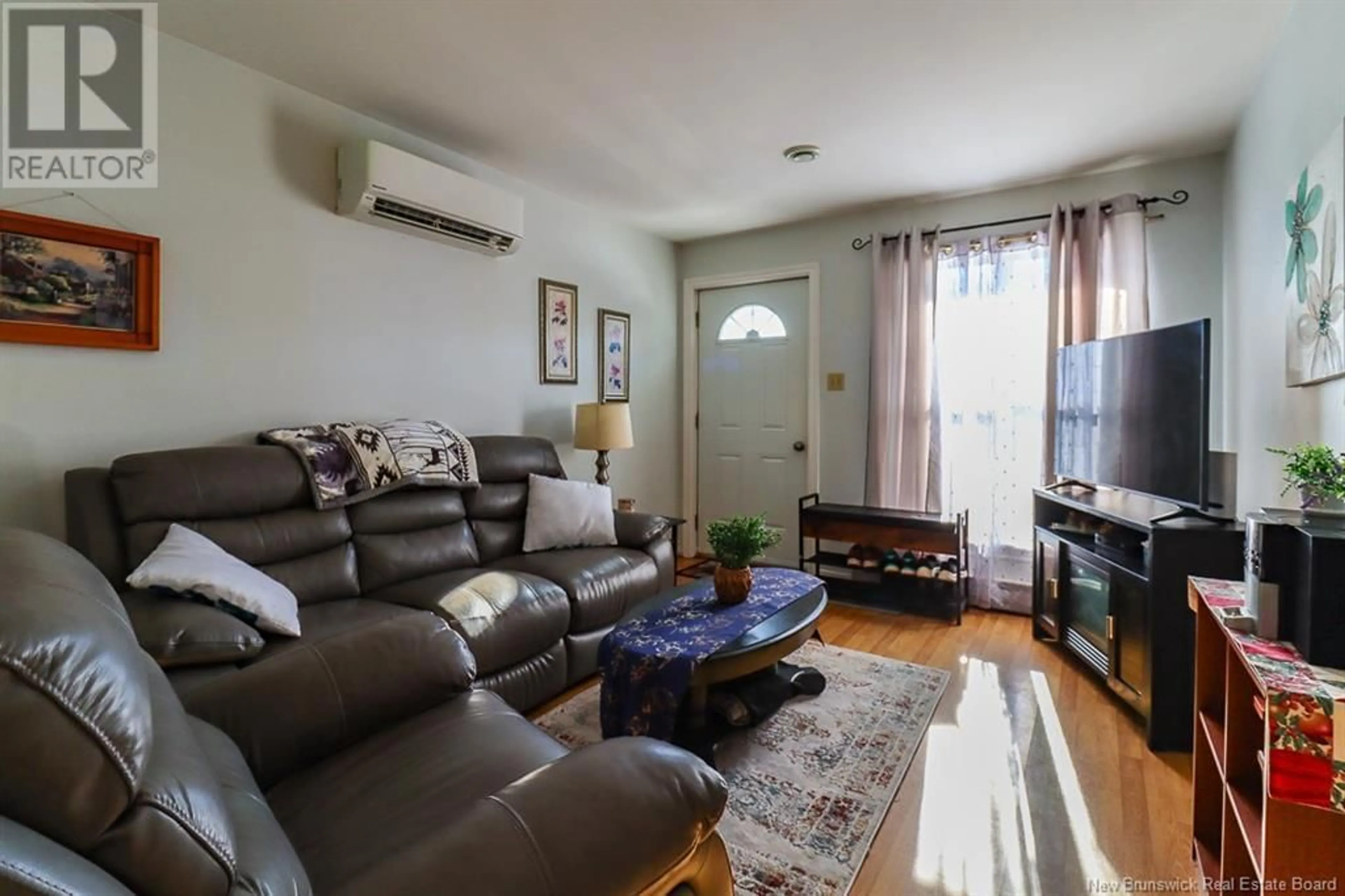 Living room with furniture, wood/laminate floor for 84 Boyaner Crescent, Saint John New Brunswick E2J4C7