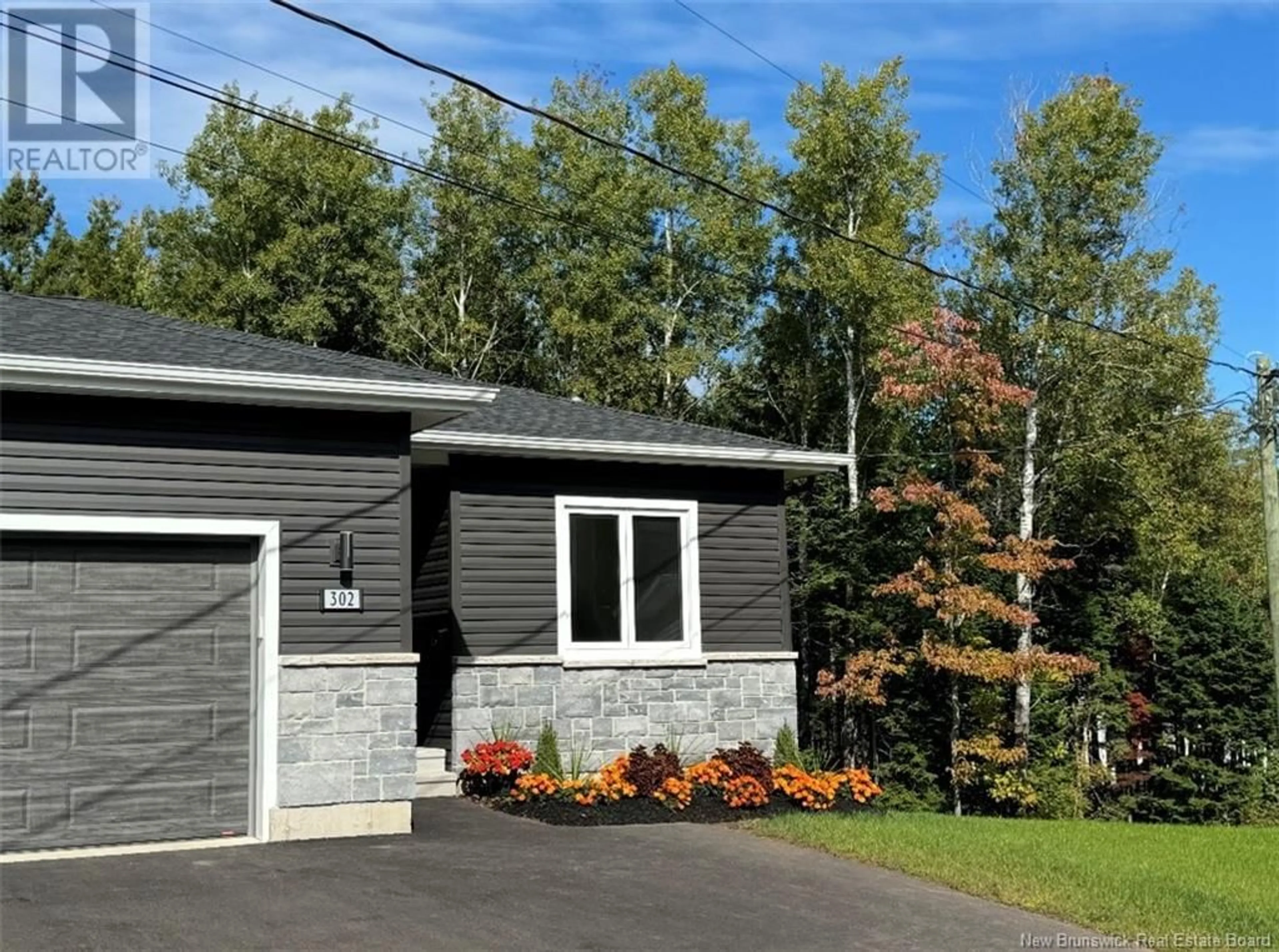 Home with vinyl exterior material, street for 302 Damien Street, Dieppe New Brunswick E1A0H3